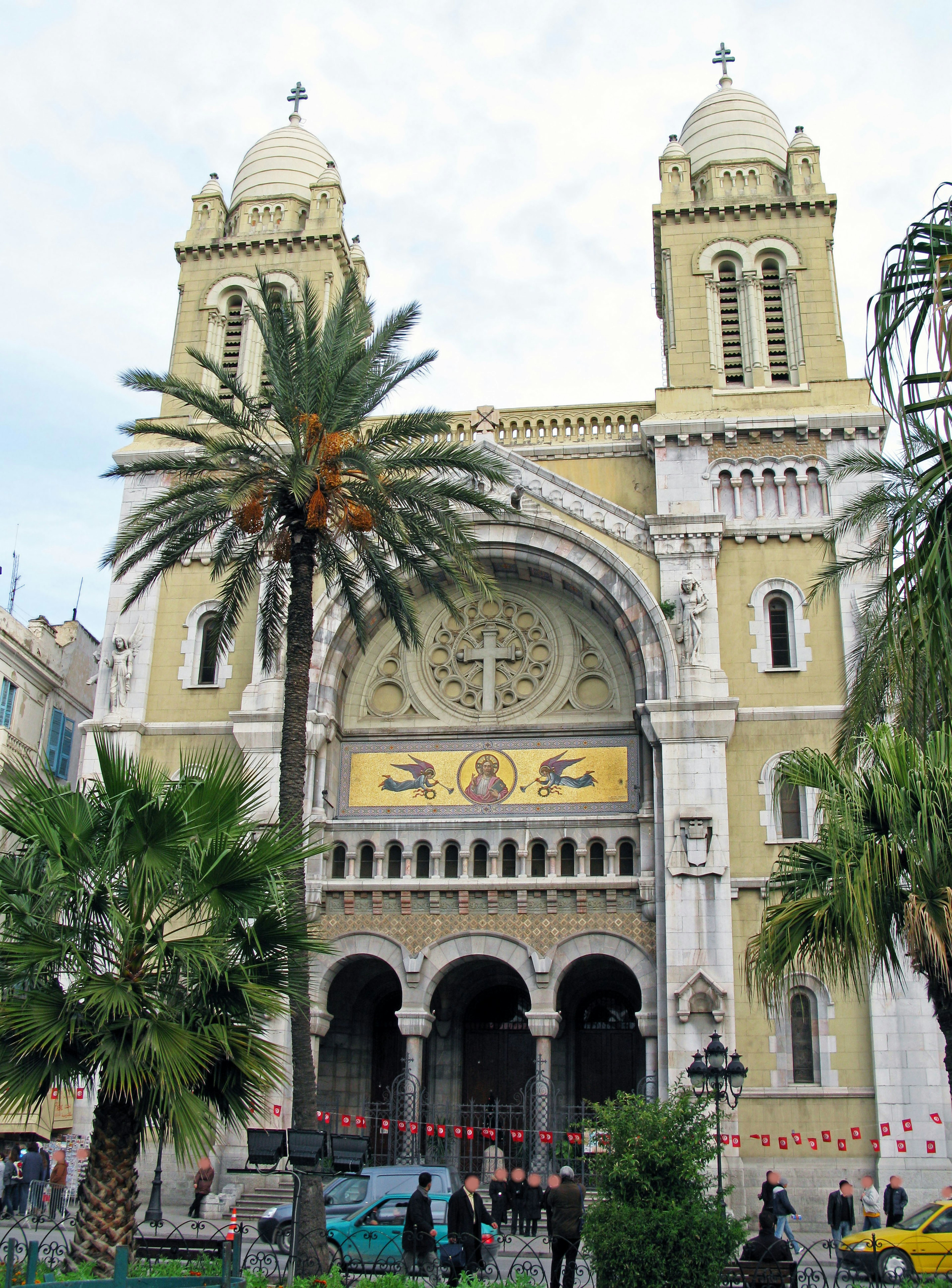 Beautiful church exterior in Cairo Egypt featuring yellow walls and ornate decorations surrounded by palm trees