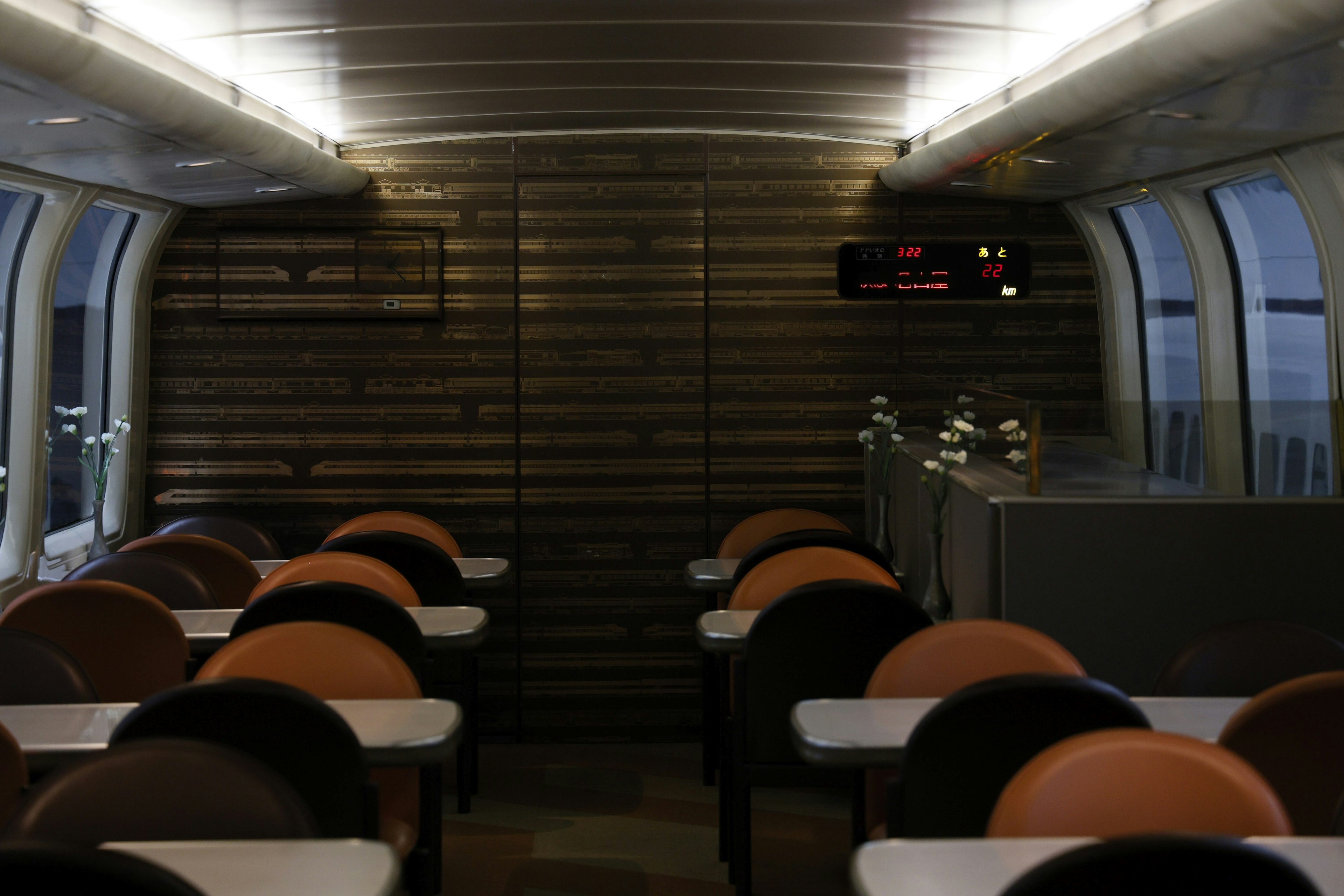 Interior of a train dining area with organized chairs and tables