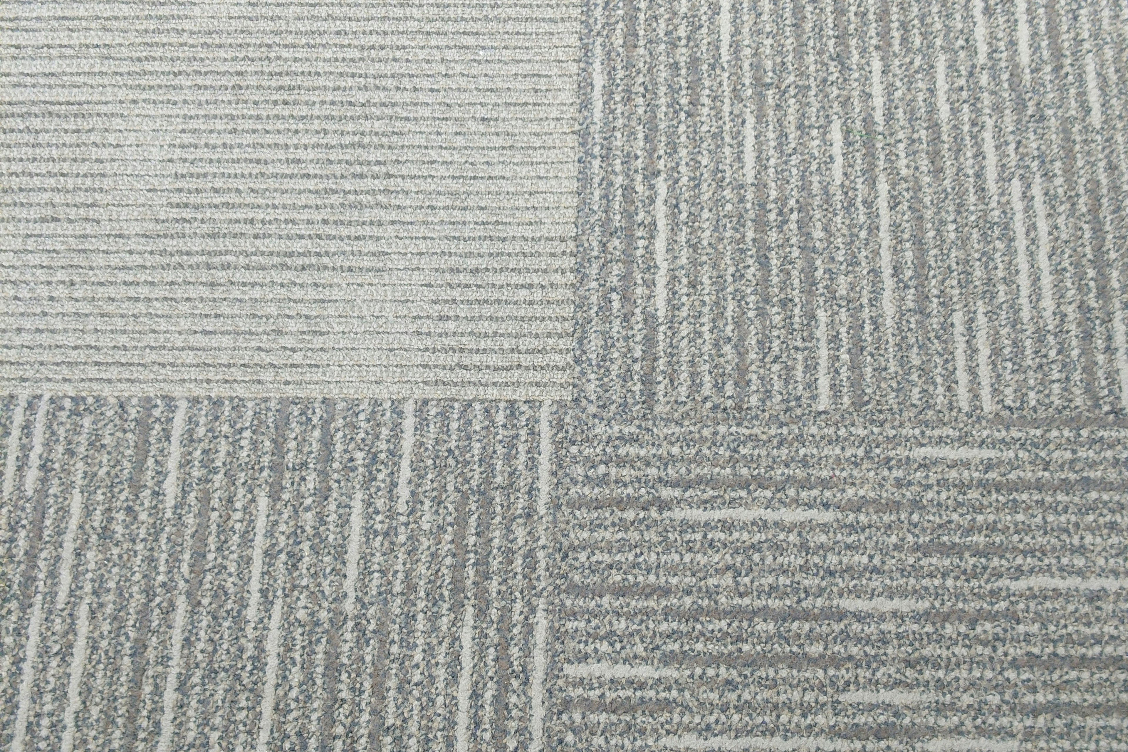 Gray patterned carpet tiles with varying textures