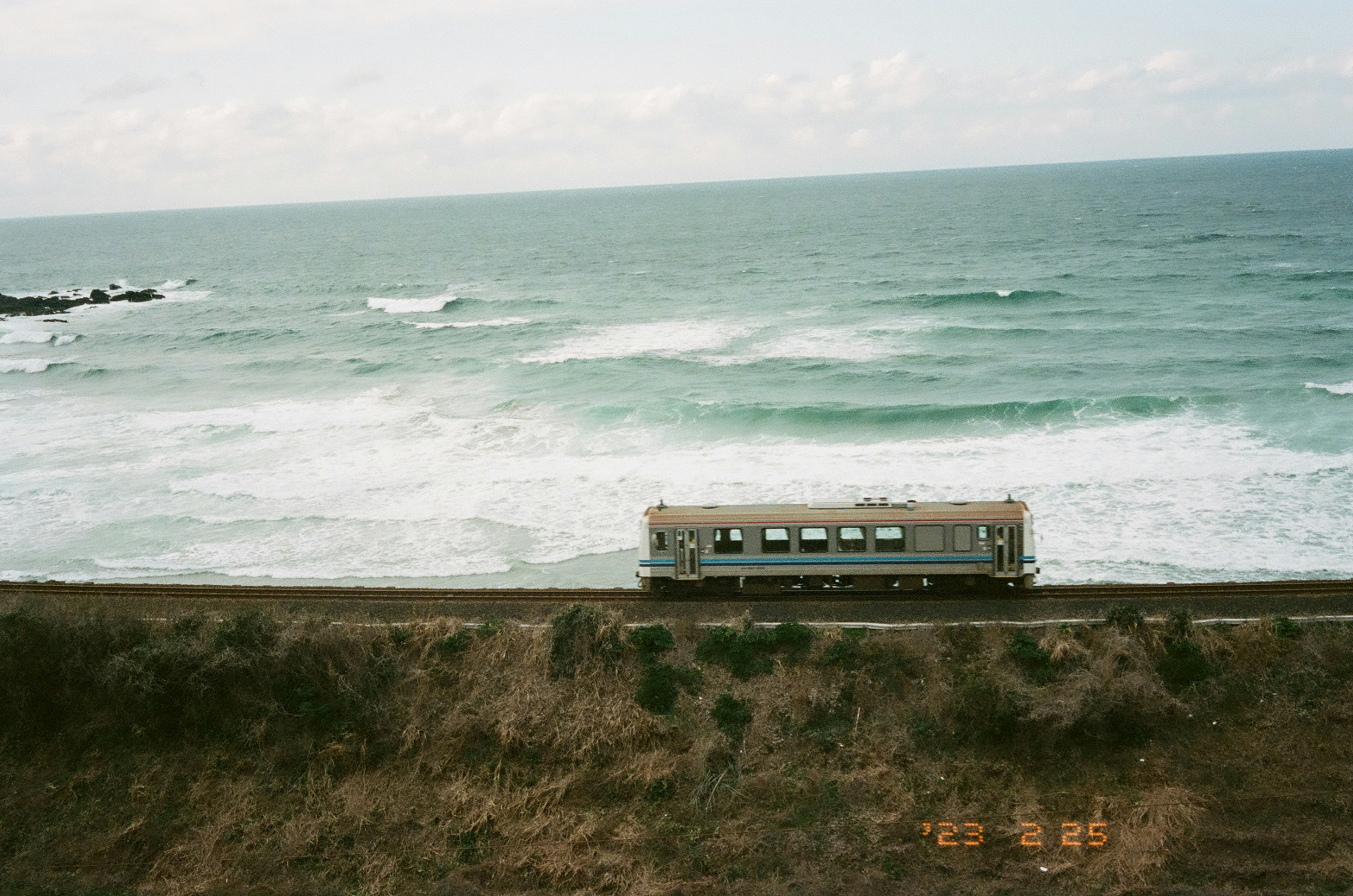 海の近くにある小さな建物と波