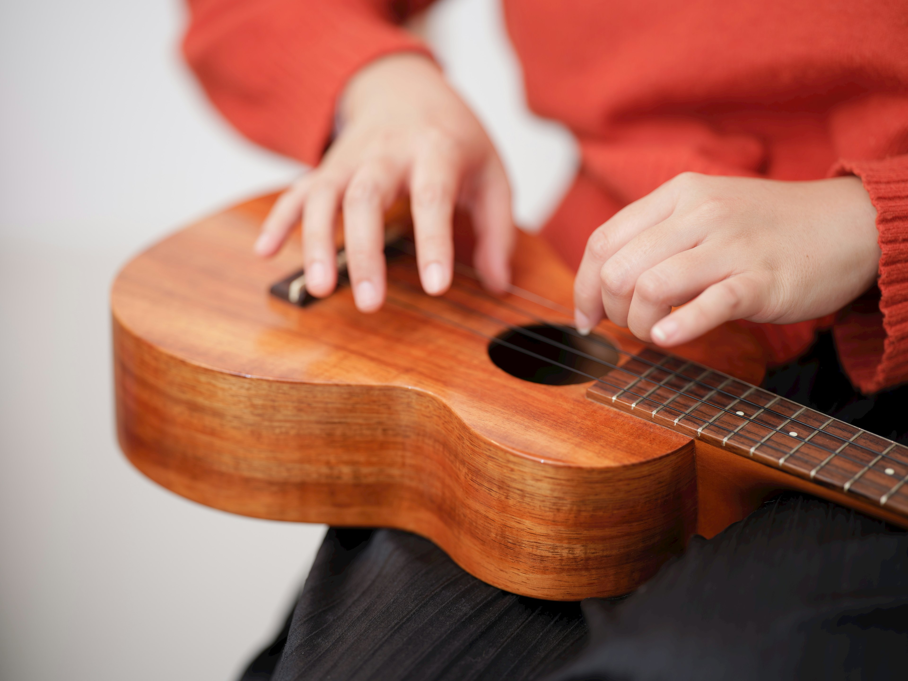 Close-up tangan bermain ukulele