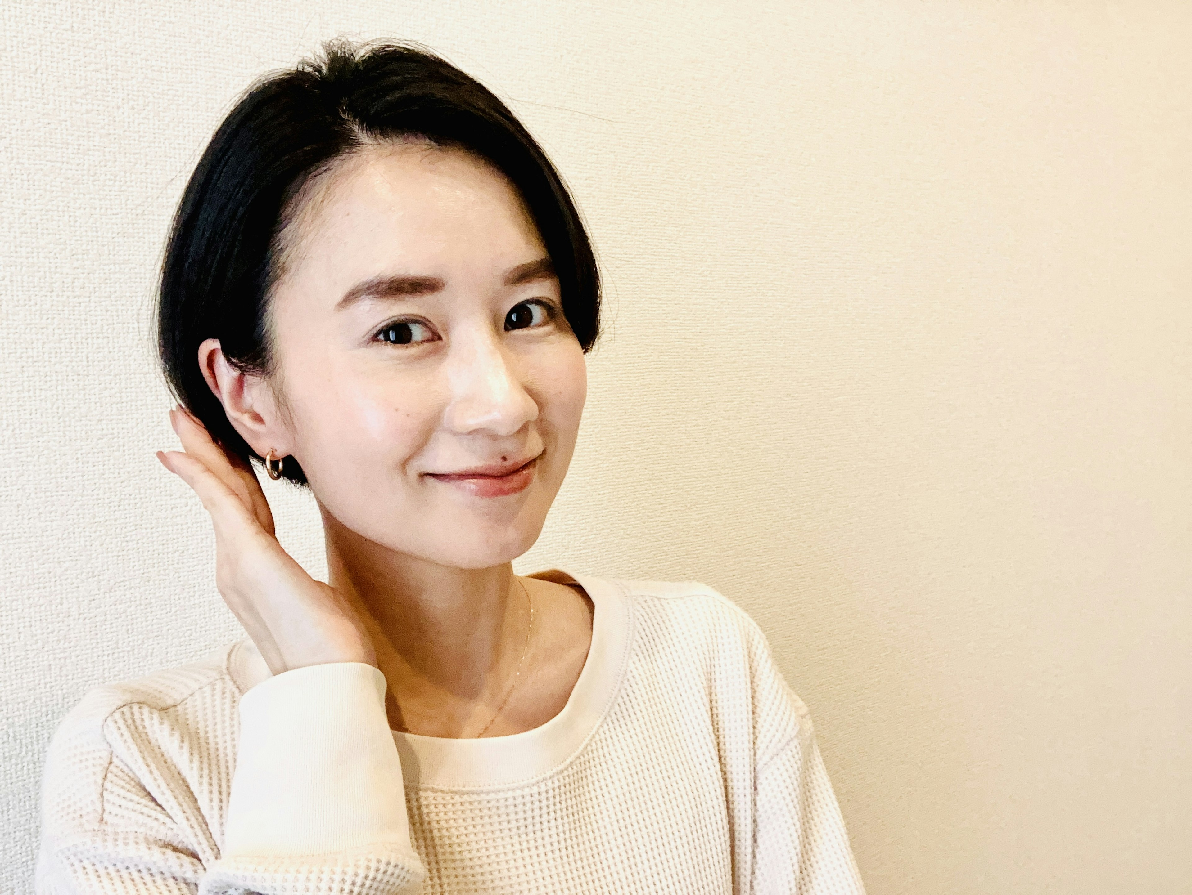 Portrait of a woman smiling against a bright background