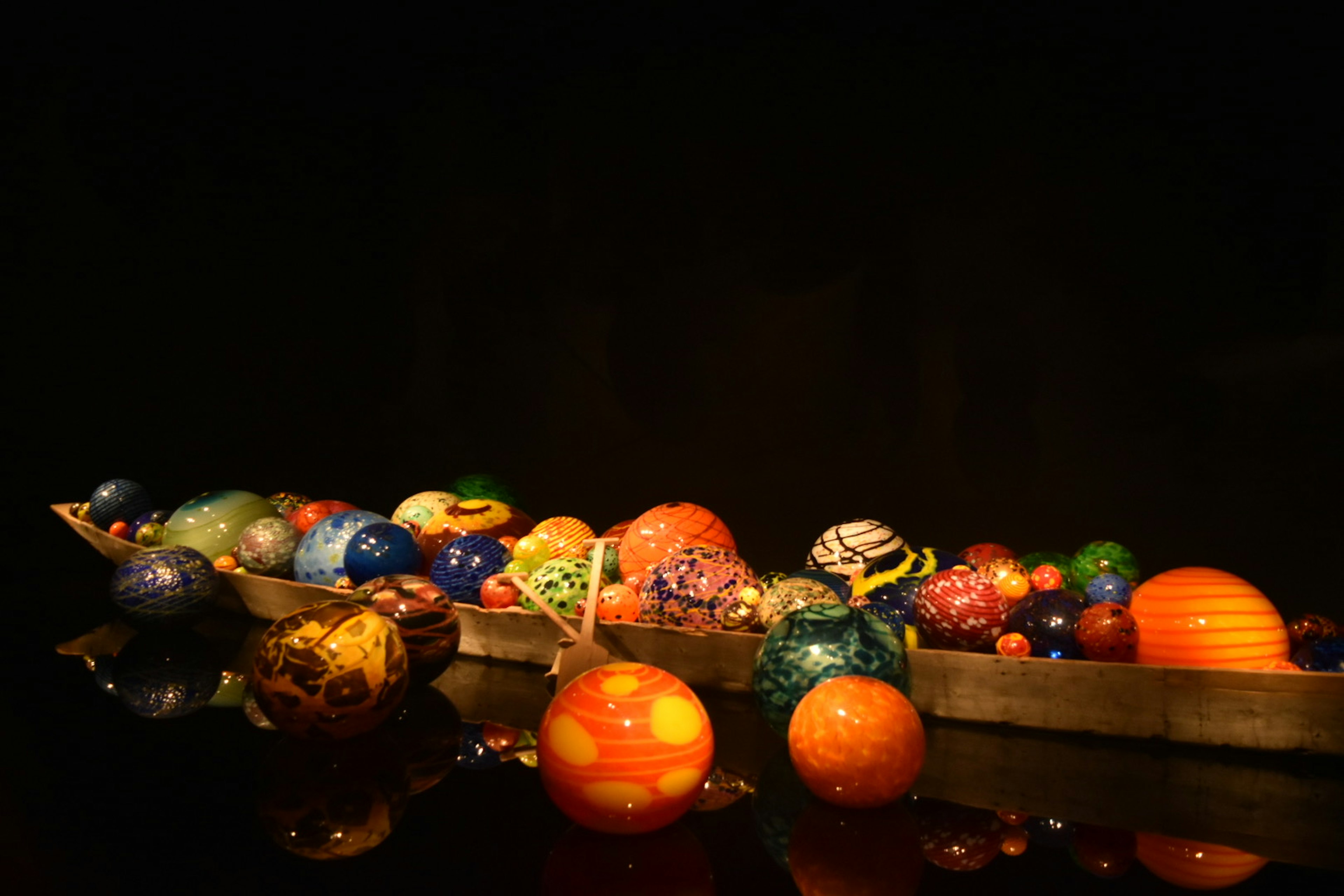 Colorful spheres arranged on a wooden boat