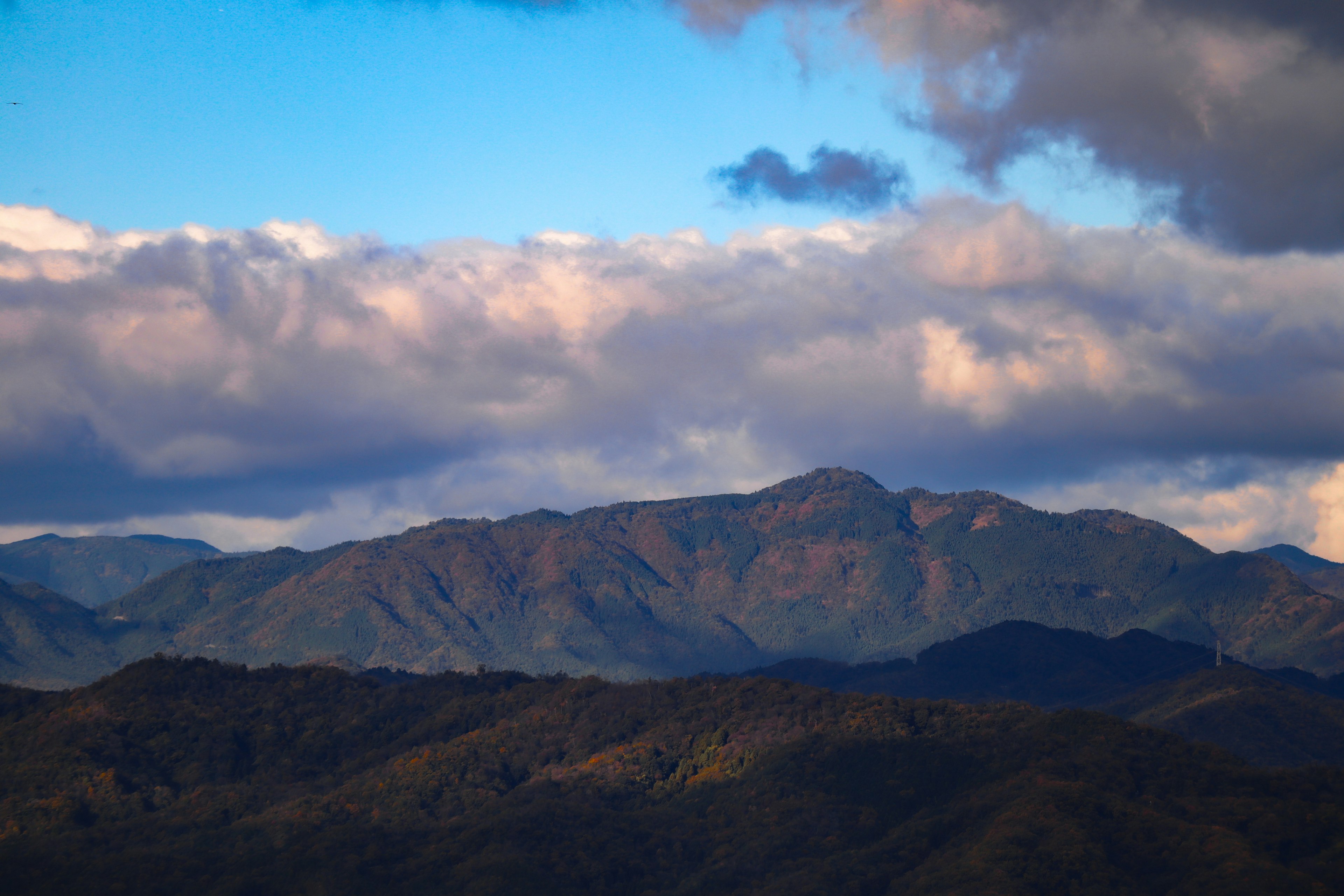 Paysage montagneux sous un ciel bleu avec des nuages