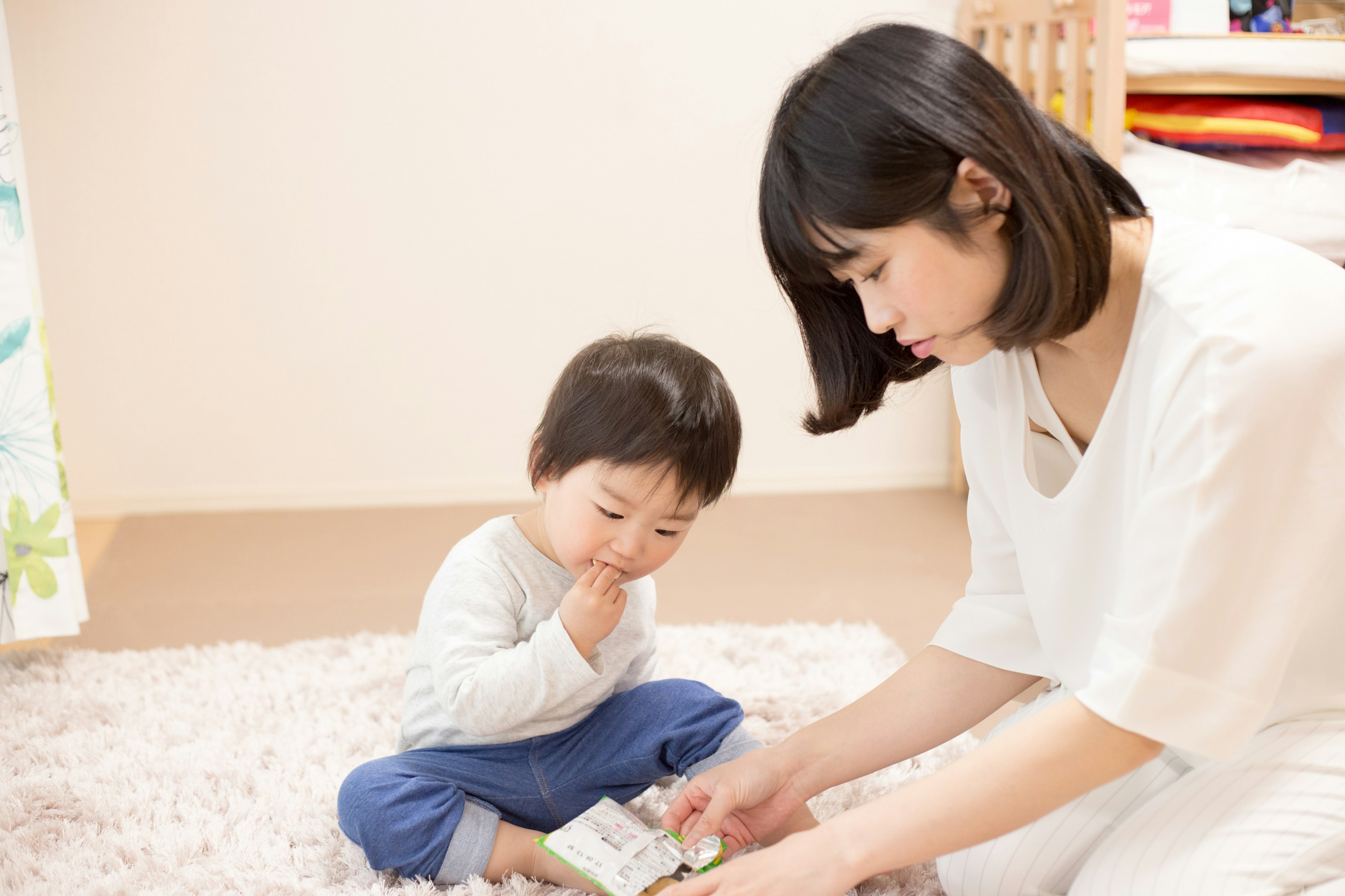 A mother interacting with her child in a cozy living room