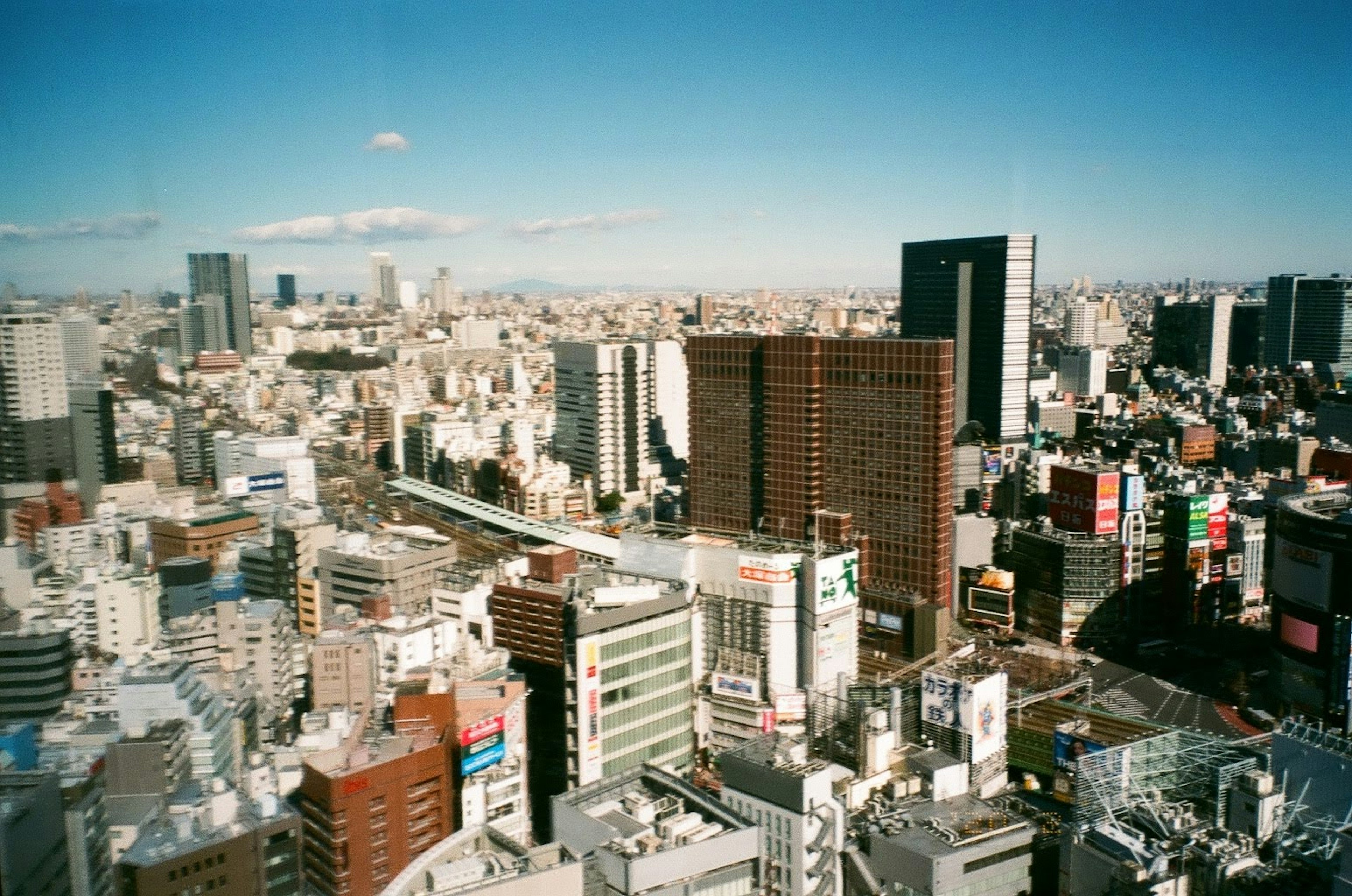 Panoramic cityscape with skyscrapers and clear blue sky