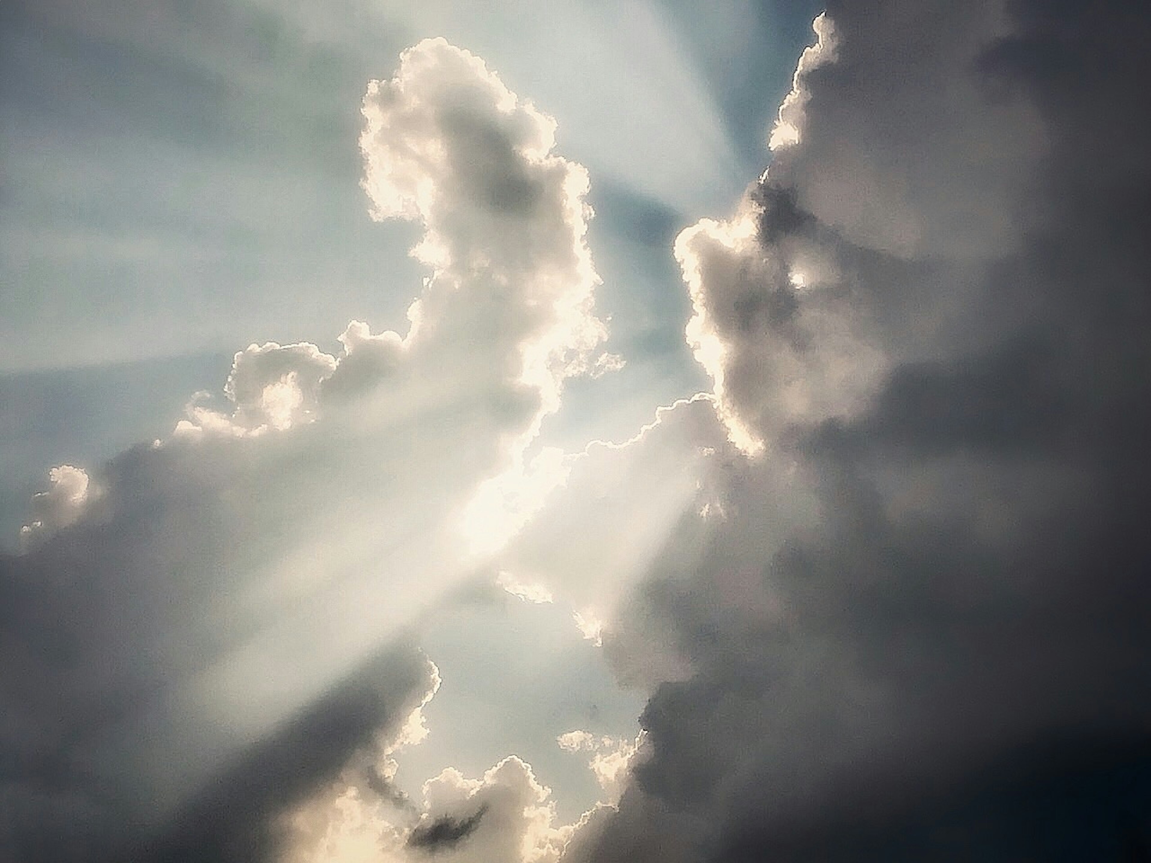 Rayos de luz brillando a través de nubes con una formación de nubes dramática