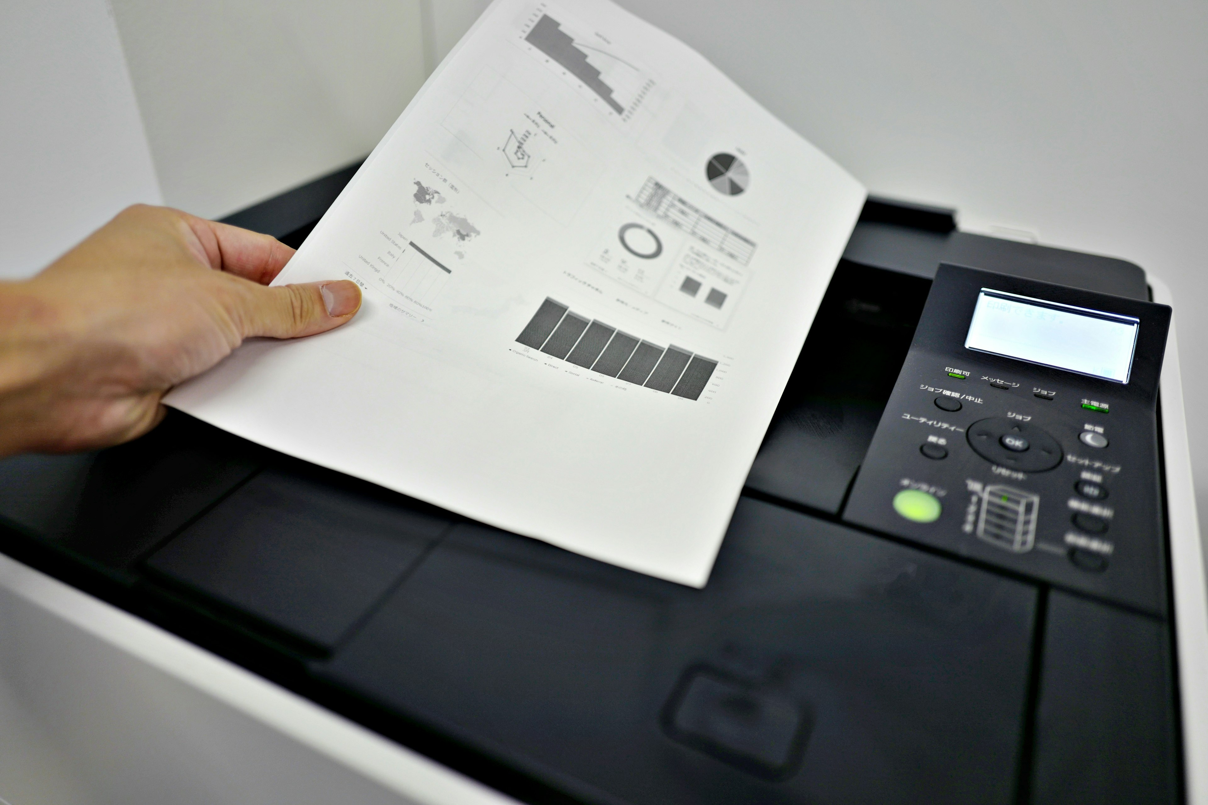 A hand placing a printed document on a photocopier