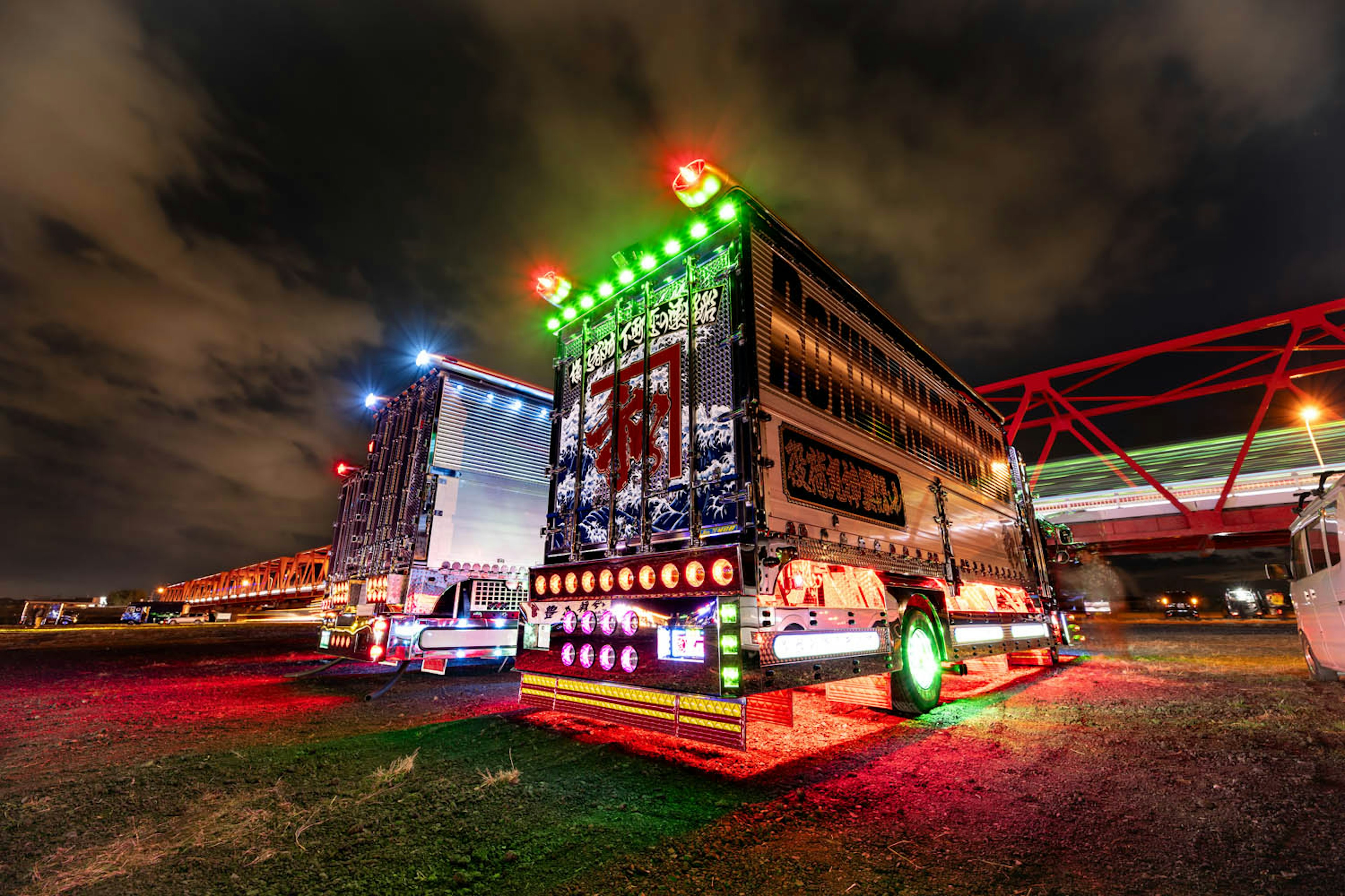 Colorful illuminated trucks at night with vibrant lights