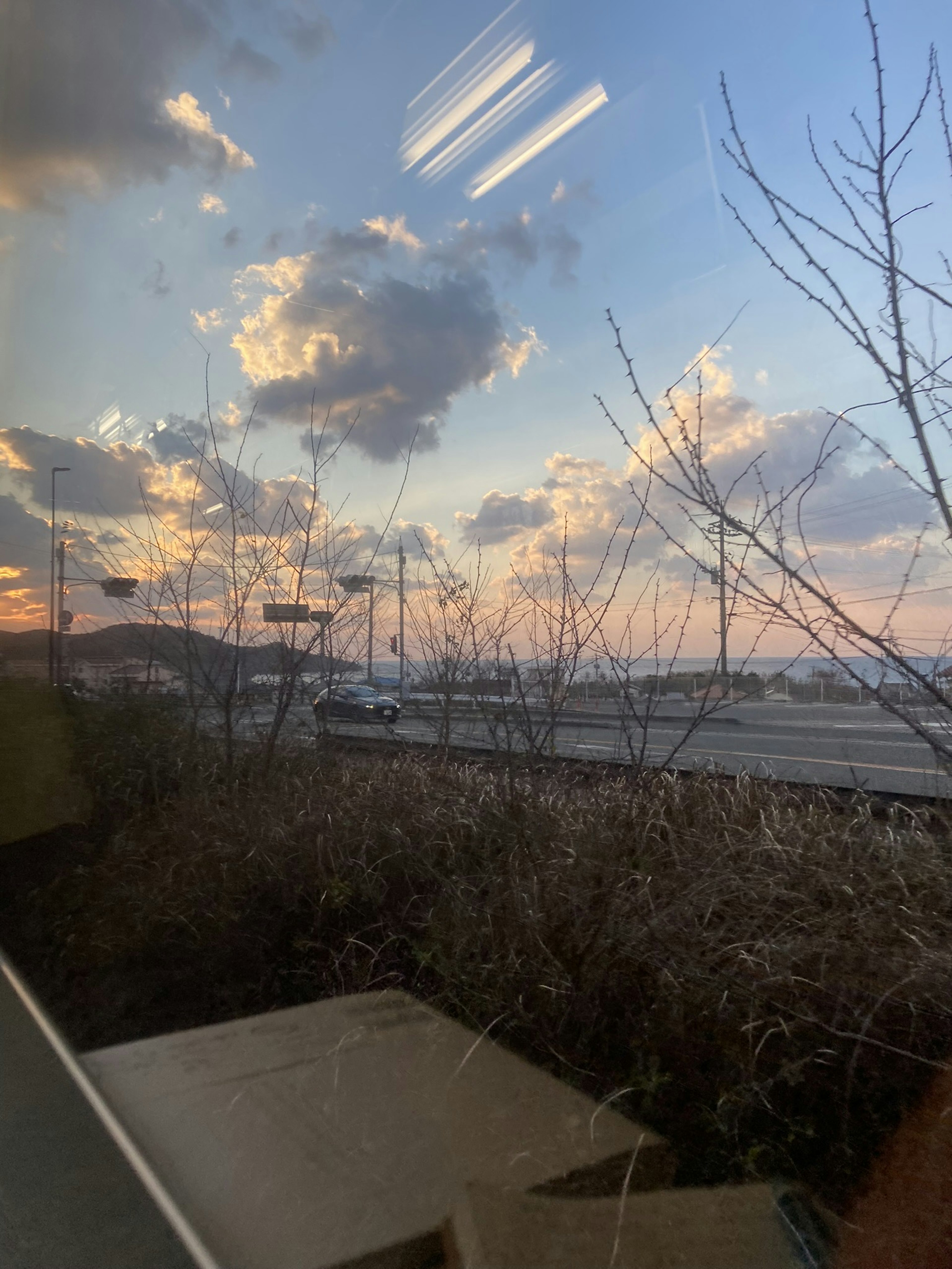 Sunset sky with clouds visible through a window