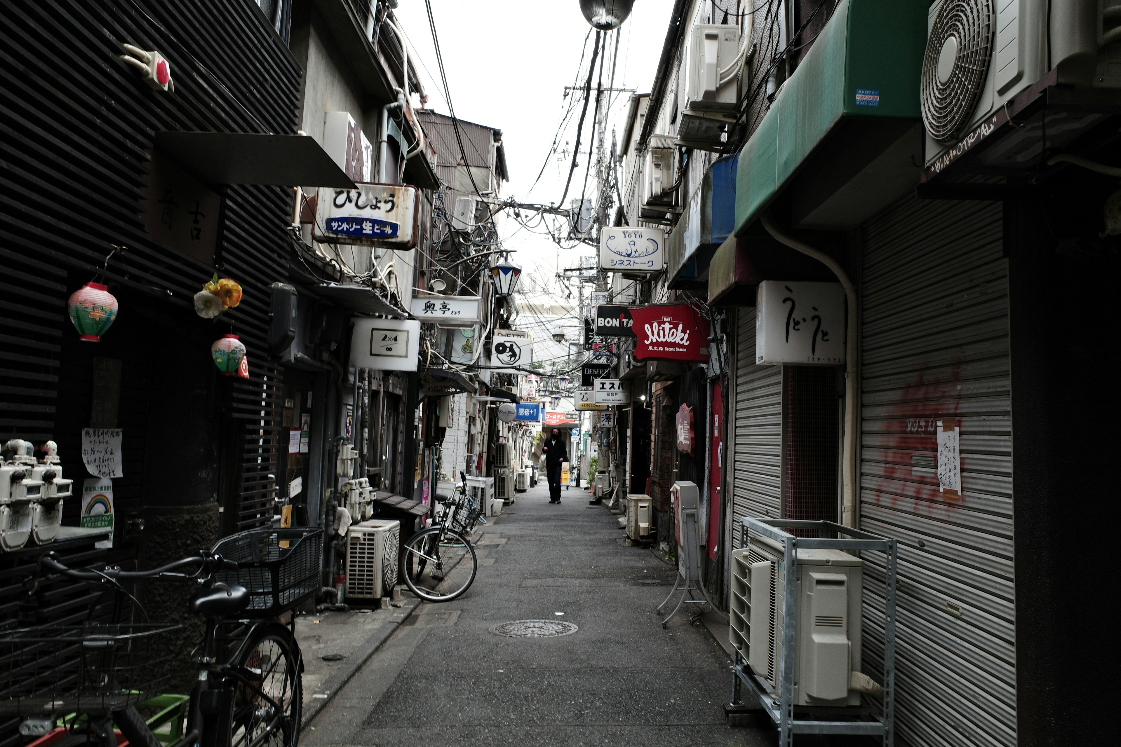 Narrow alley with small shops and bicycles lining the street