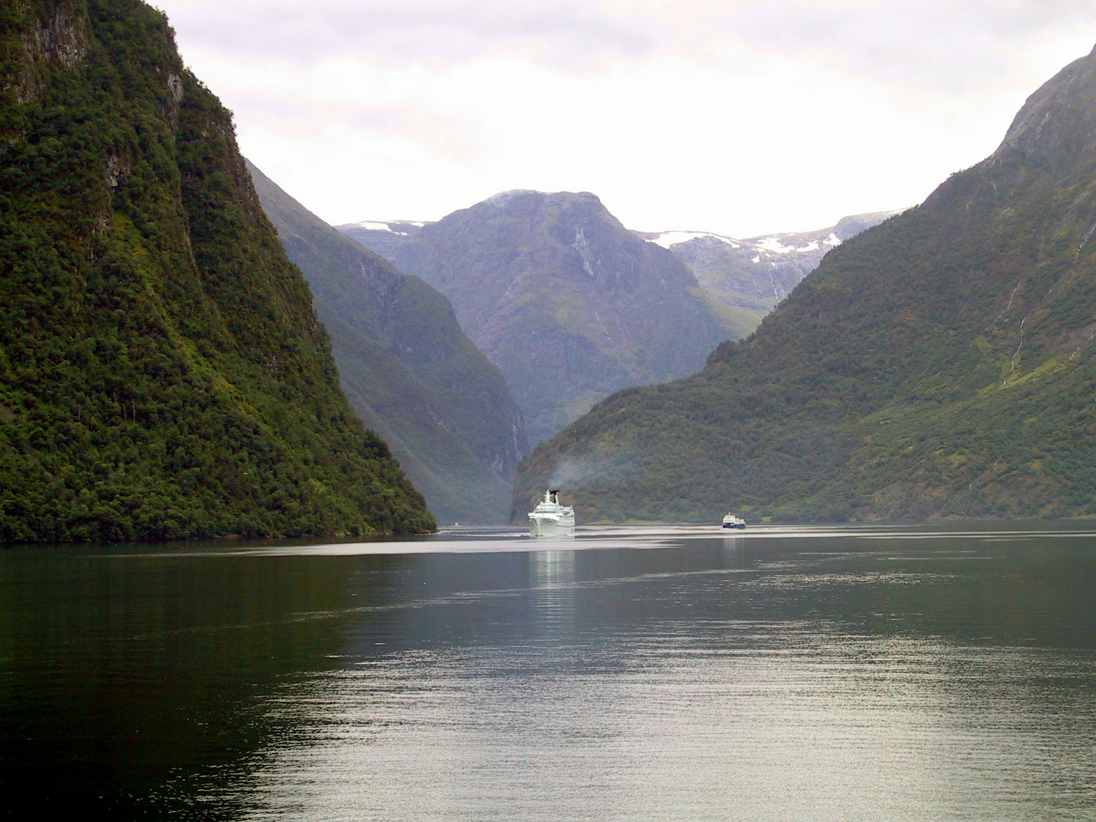 Scenic fjord view with a boat in the distance