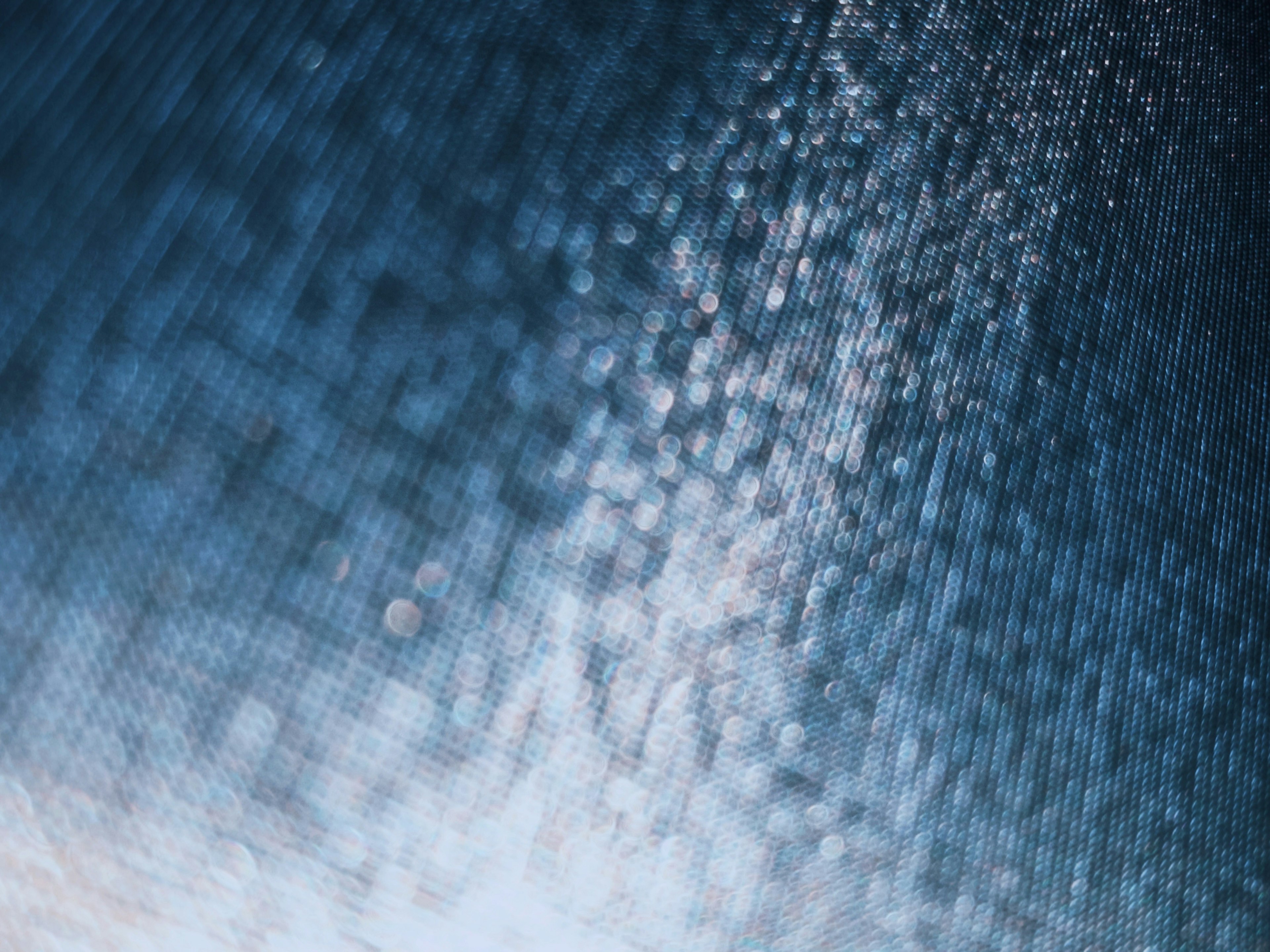 Close-up of water droplets on a textured blue surface