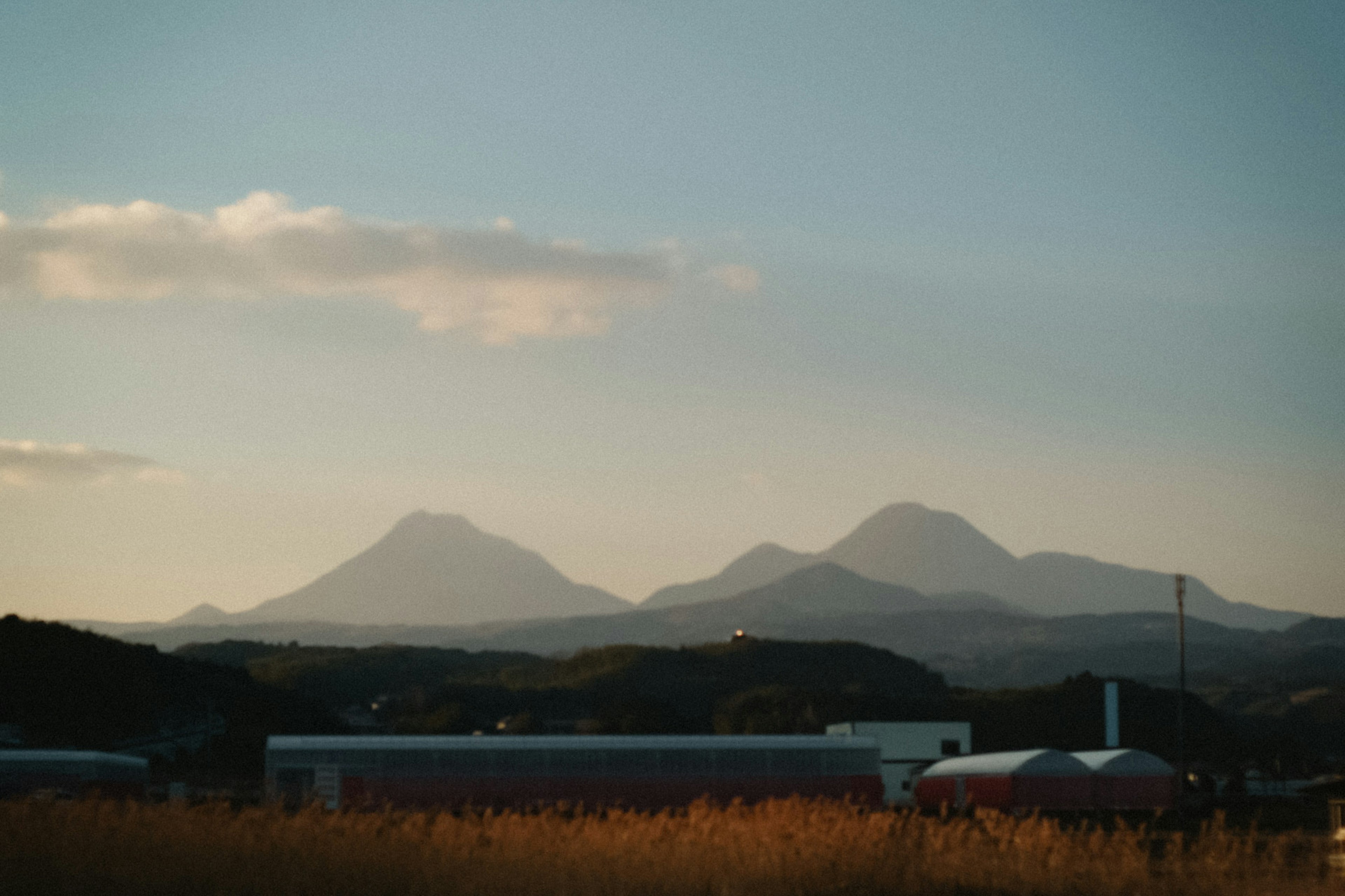 Landscape featuring mountains under a sunset sky