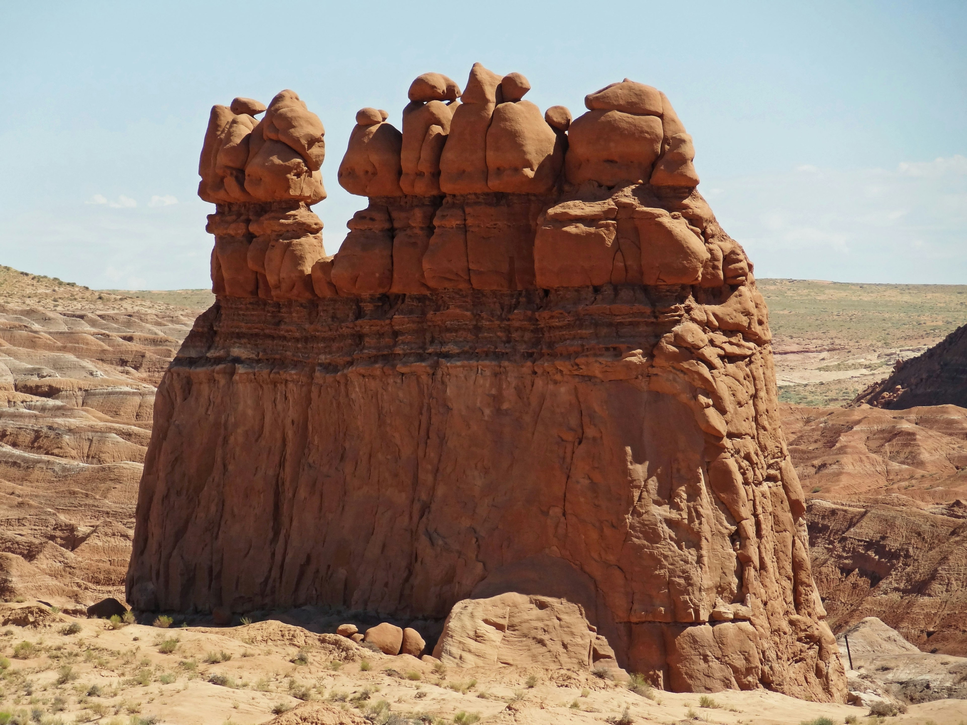 Unique natural rock formation with red hues and distinct shapes