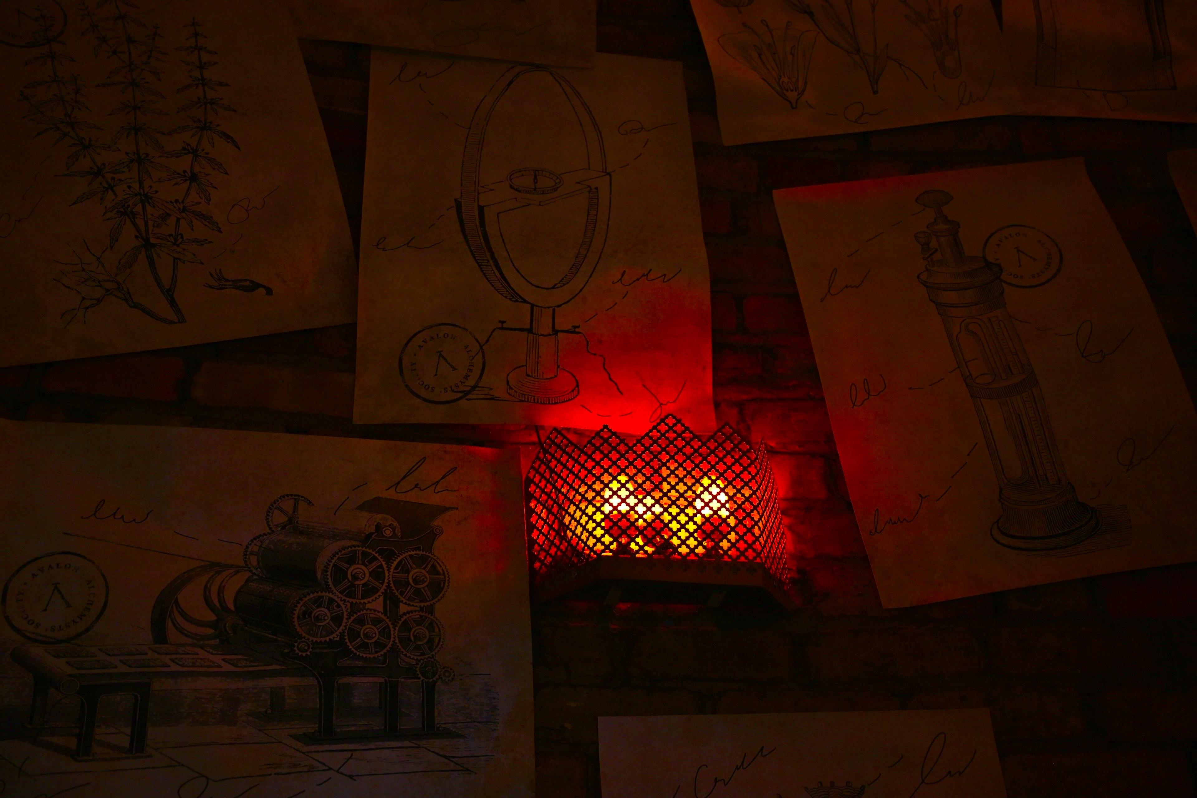 Art space with sketches on the wall illuminated by red light