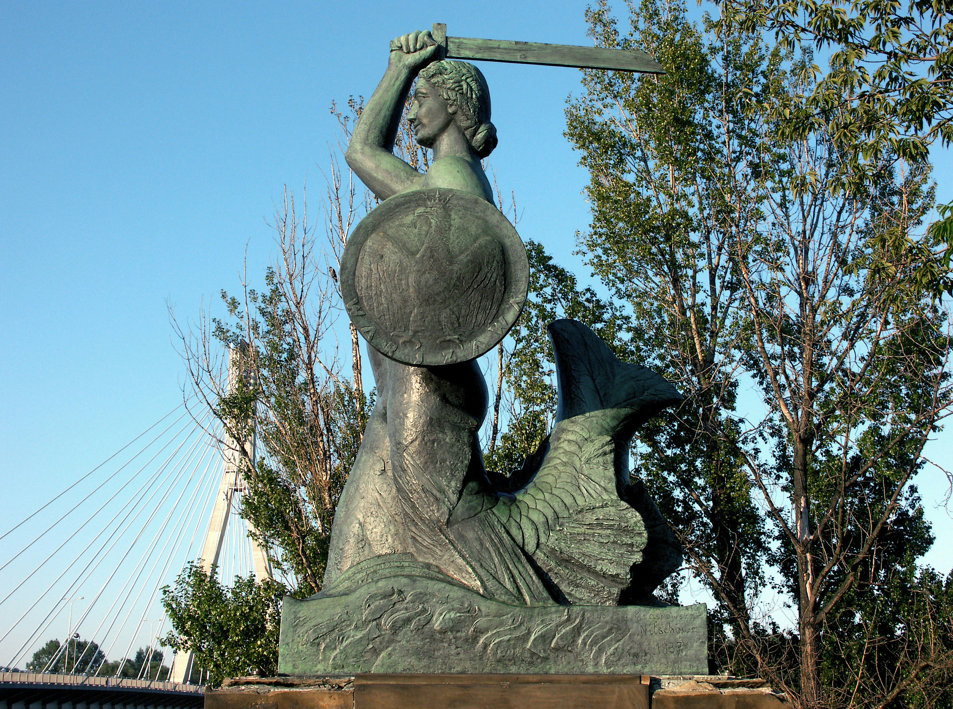 Statue of a female warrior holding a shield and sword in a heroic pose