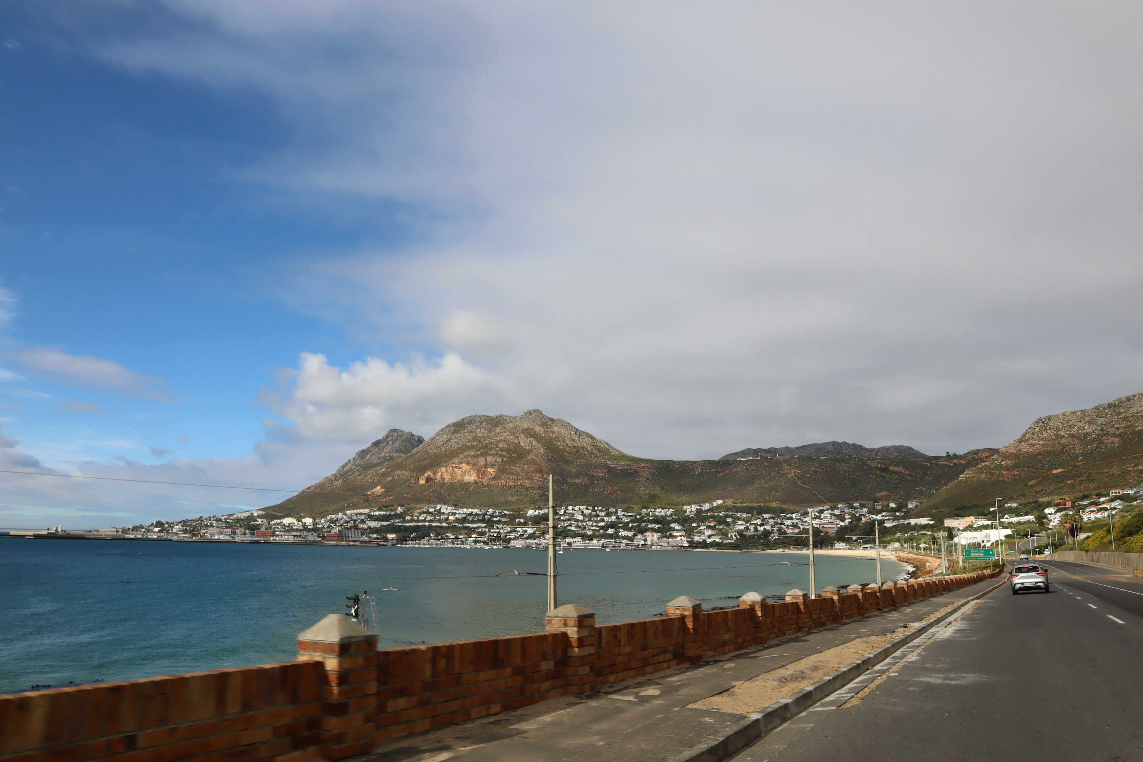 Coastal road view with mountains and sky