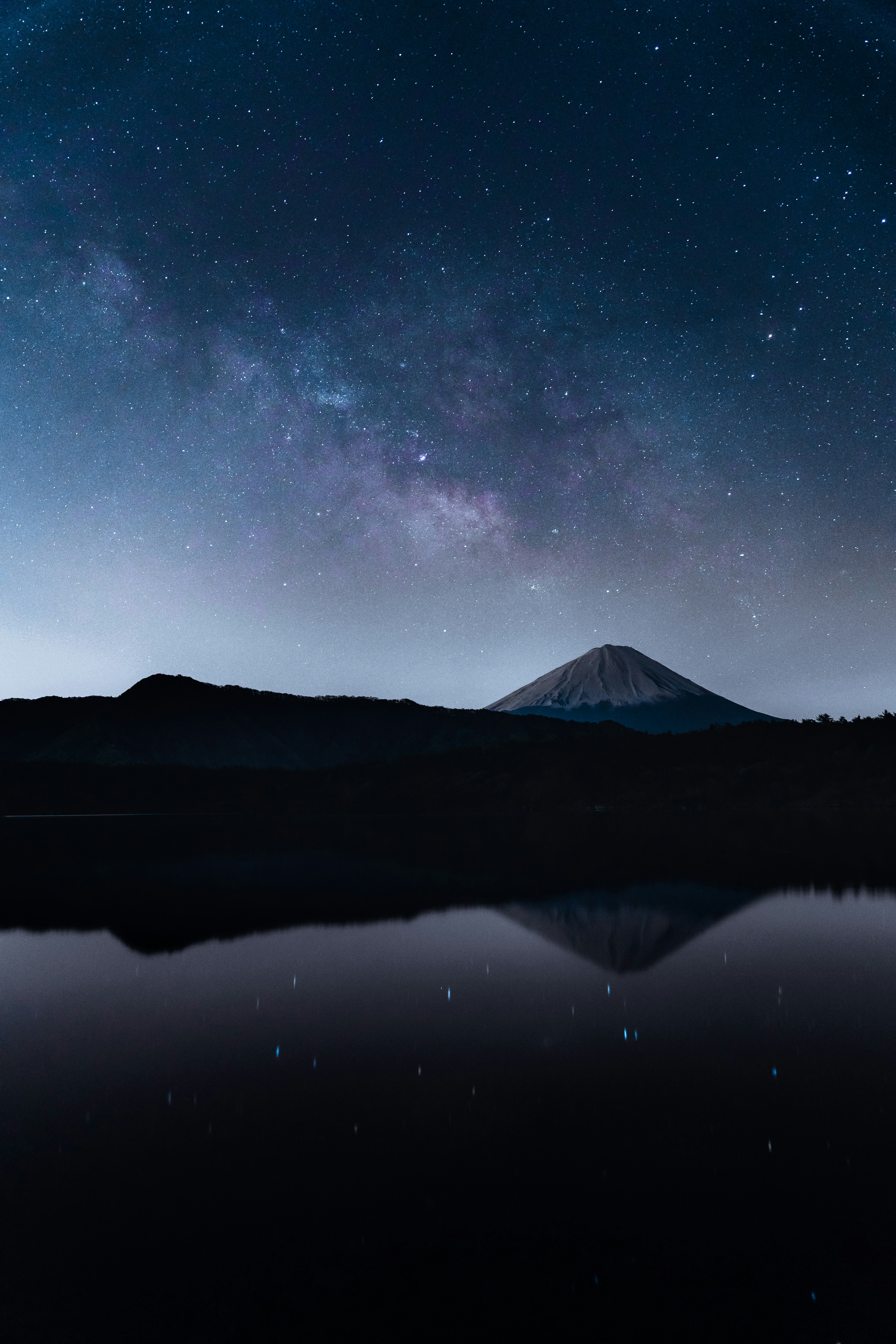 星空と湖の反射が美しい風景 夜空に広がる銀河と山のシルエット