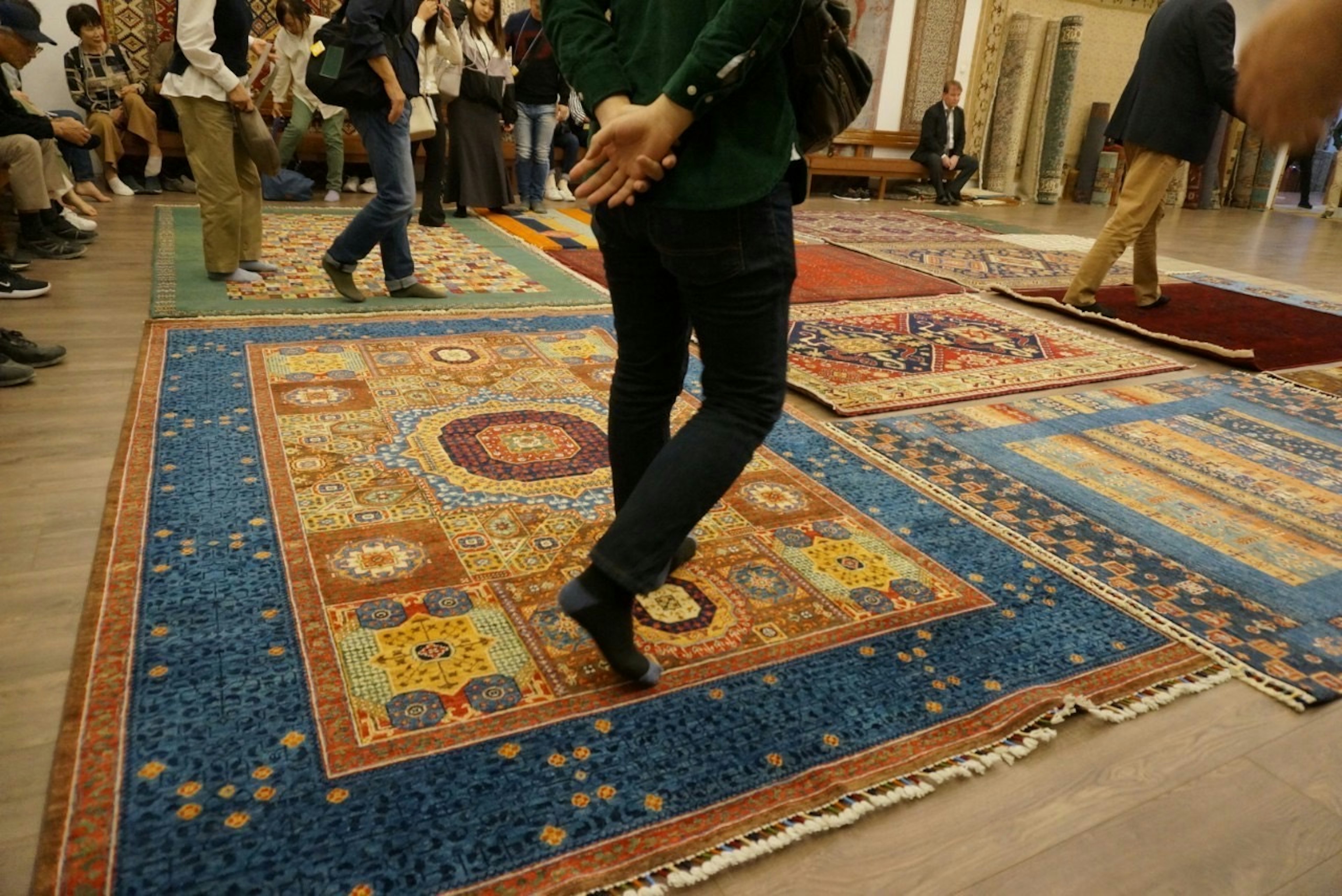 Visitors walking on colorful carpets in a display setting