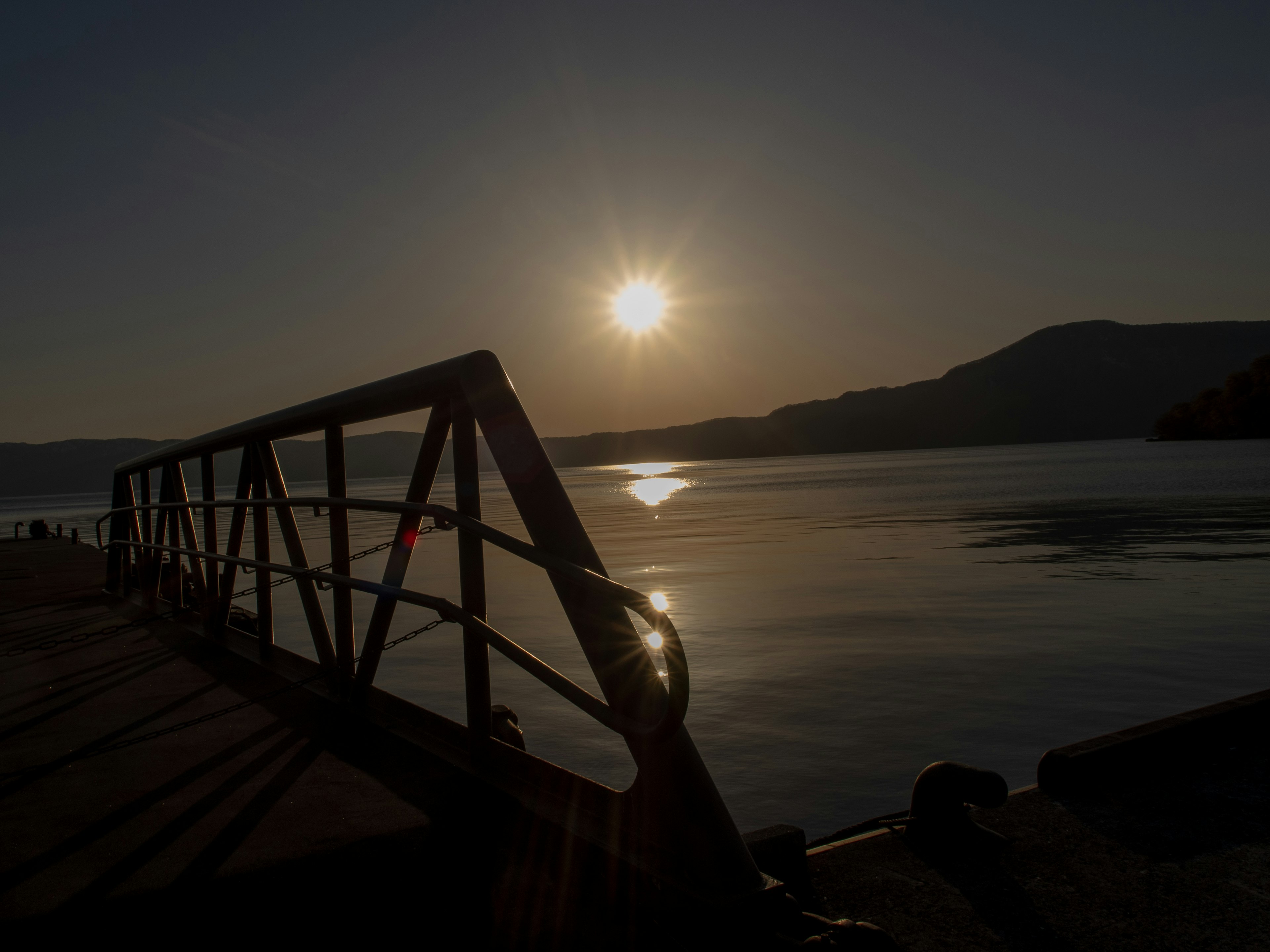 Serene lake view with sunset reflecting on the water