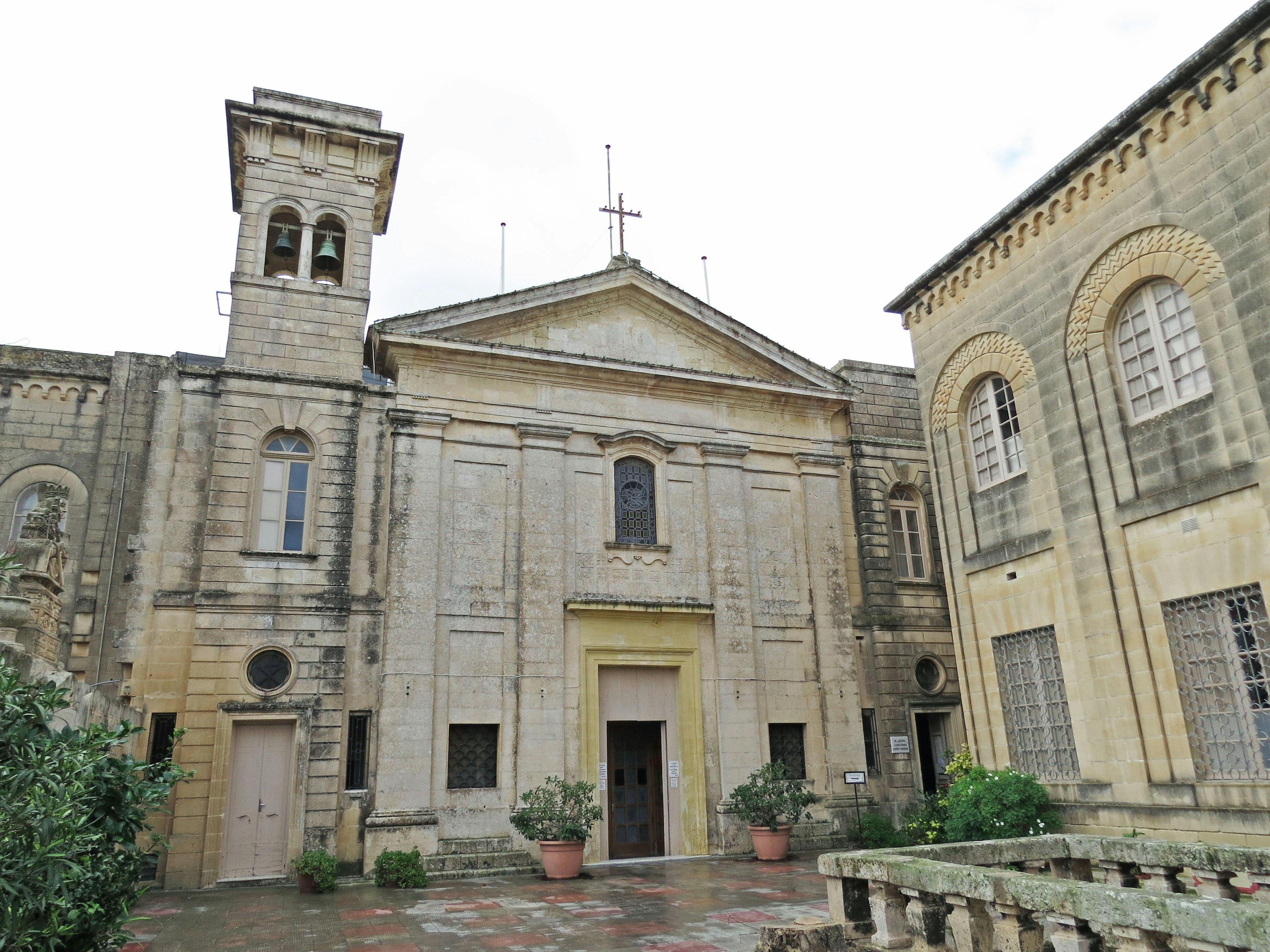 Facade of an old church with surrounding garden