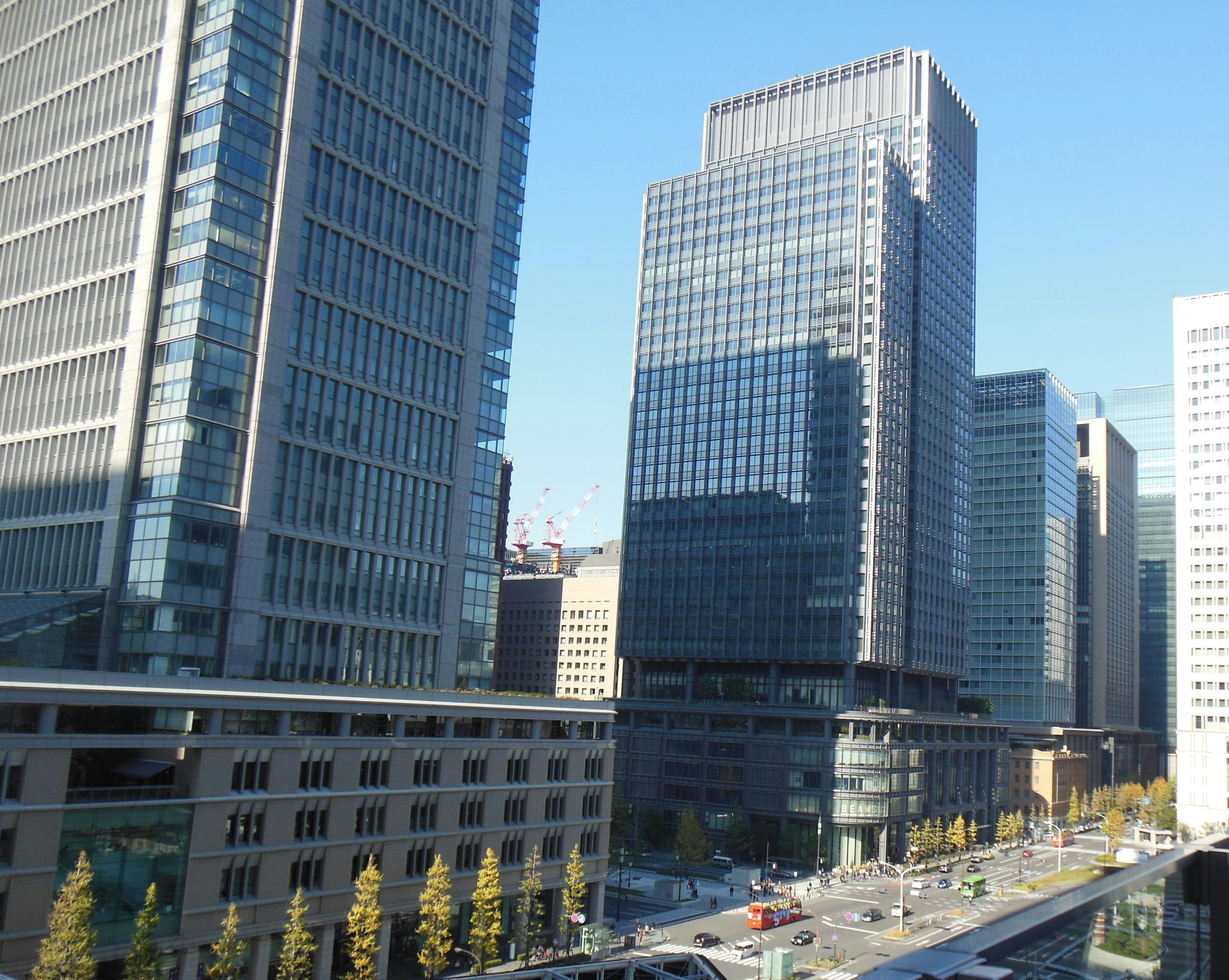 Cityscape featuring tall buildings under a bright blue sky