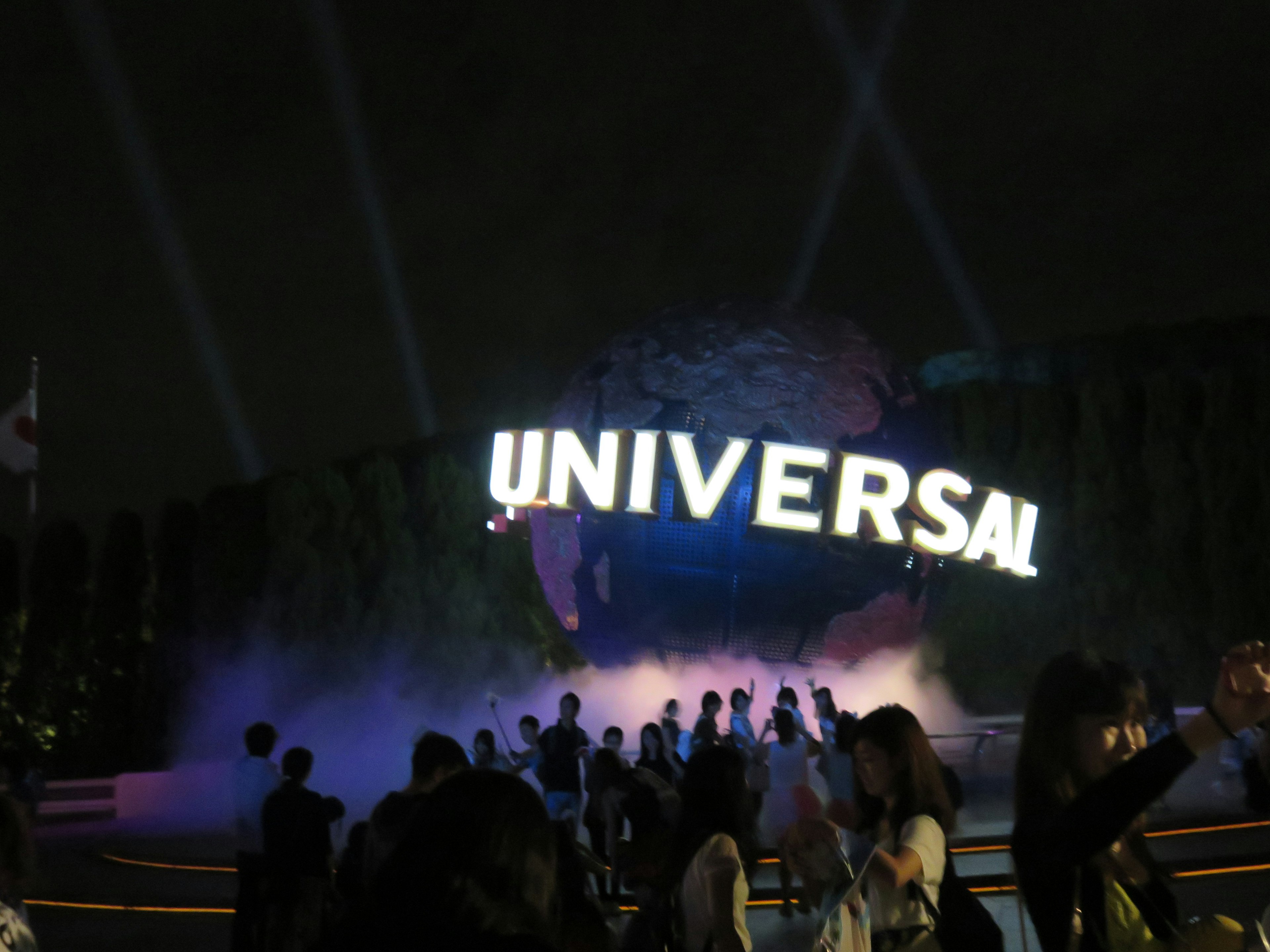 Night scene featuring the Universal sign with light effects