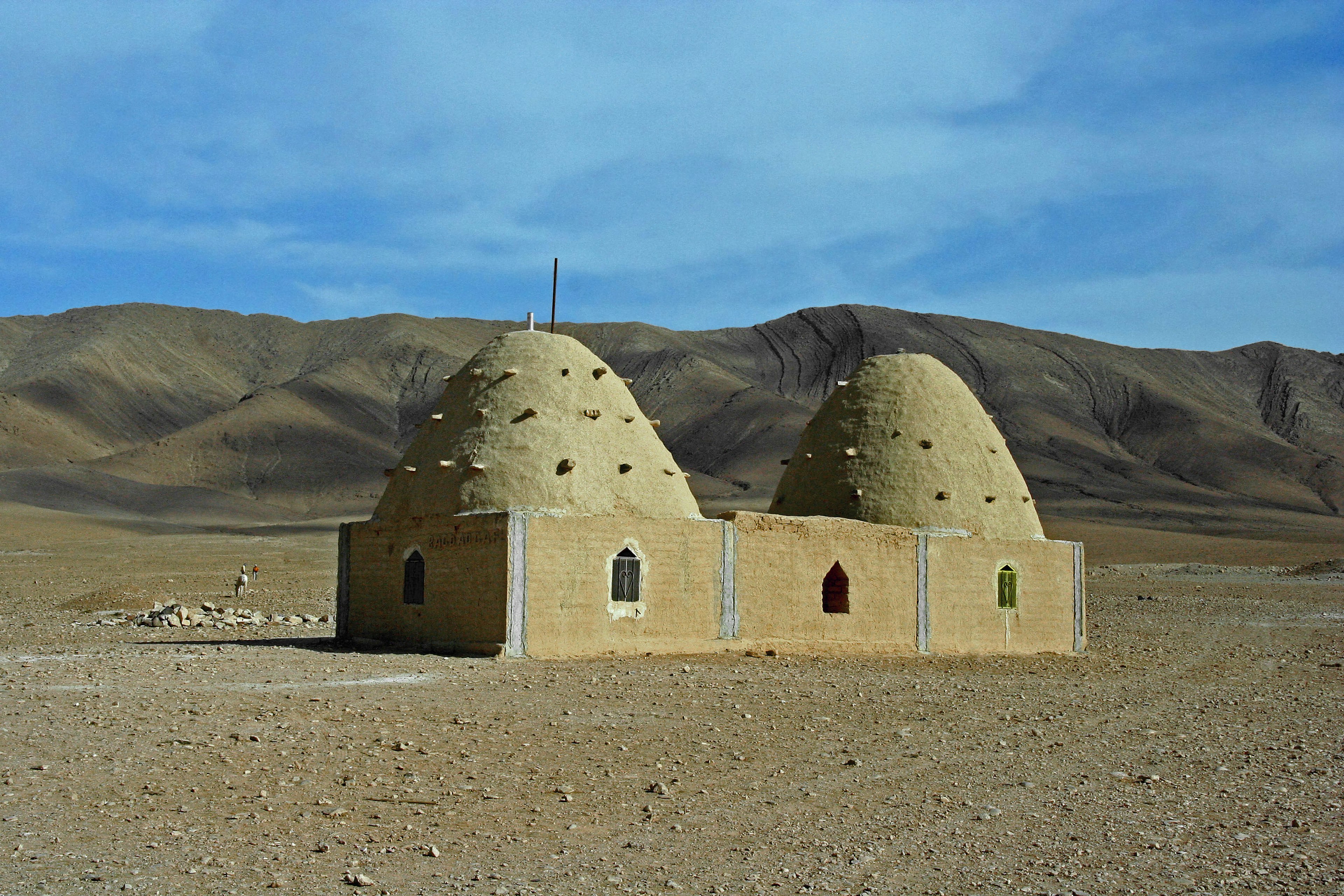 Due edifici a forma di cupola distintivi in un vasto paesaggio desertico