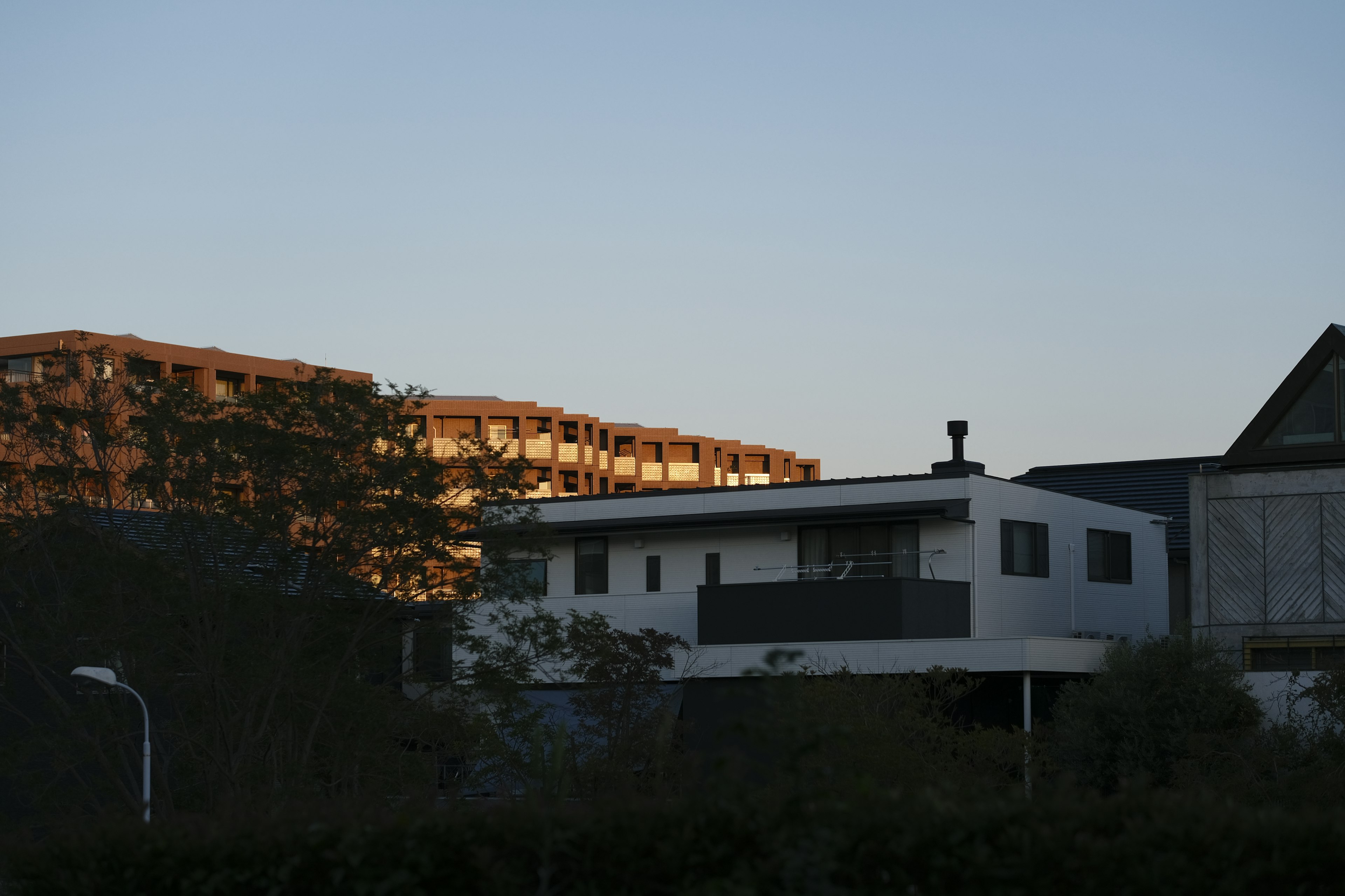 Residential neighborhood at sunset with various buildings