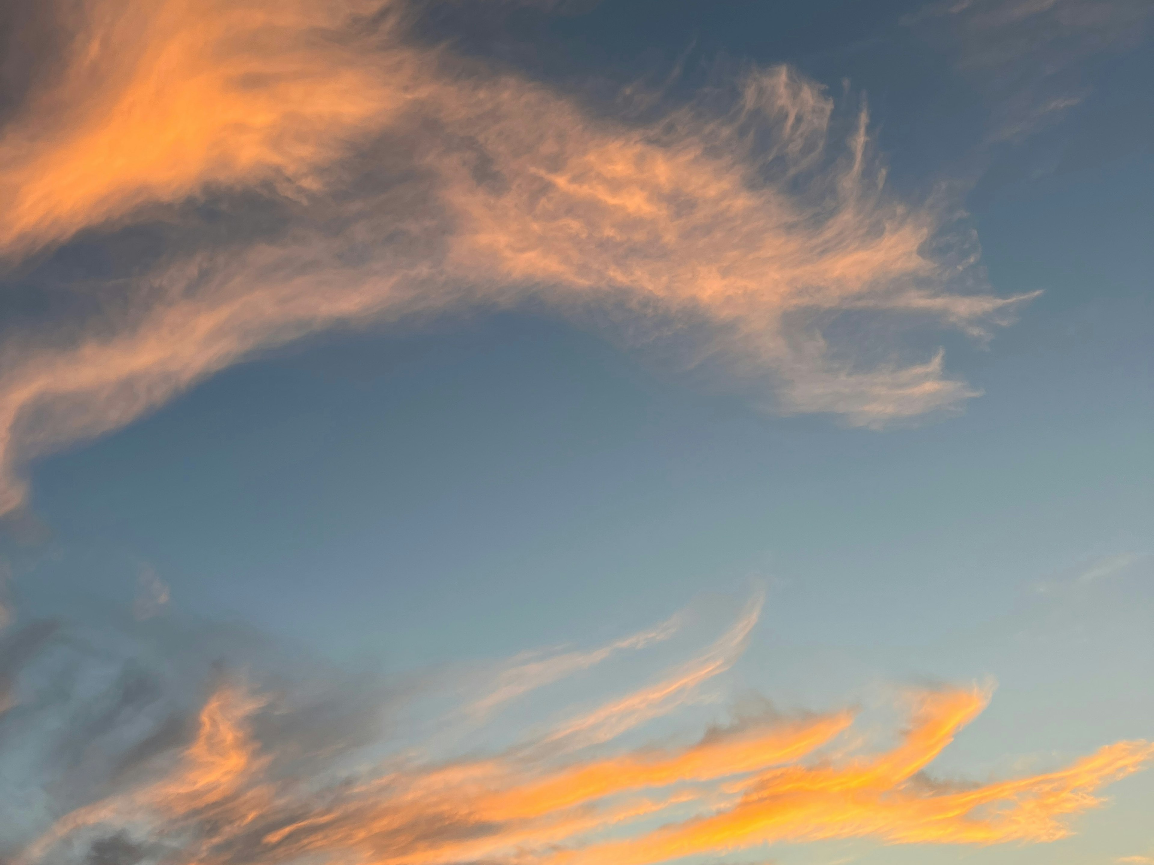 Orange clouds against a blue sky during sunset