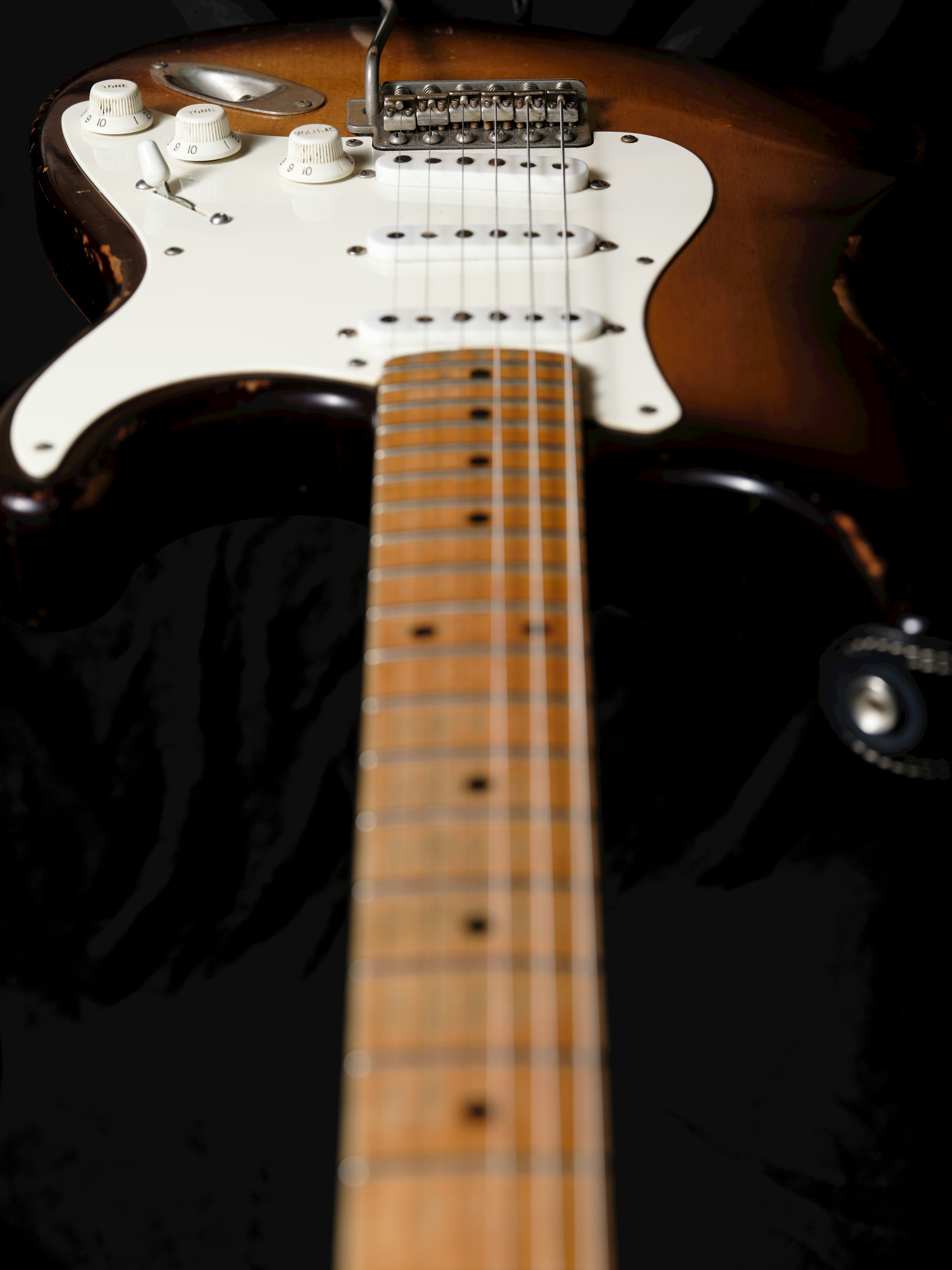 Close-up photo of a guitar body and neck