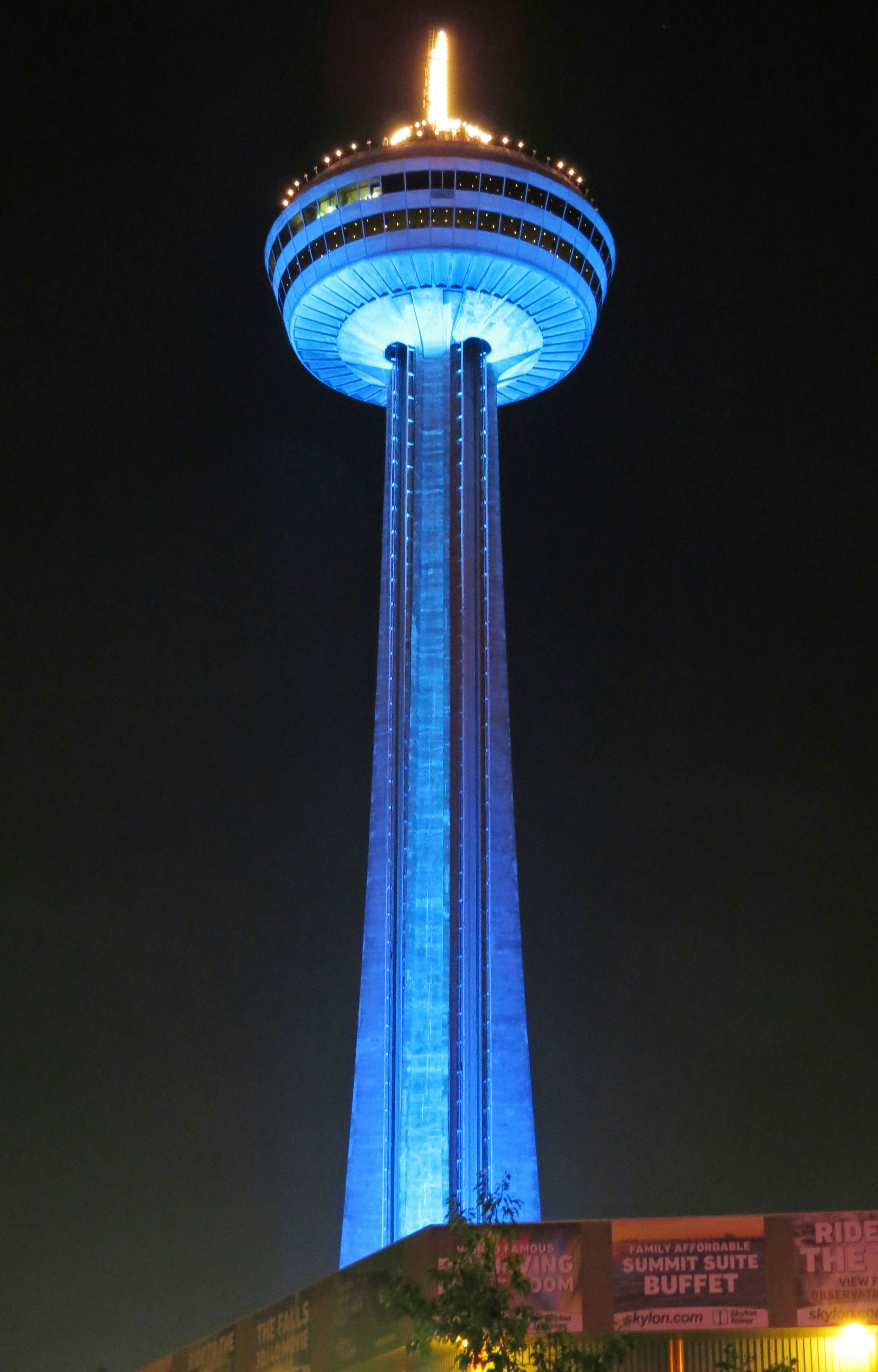 A blue-lit tower near Niagara Falls at night