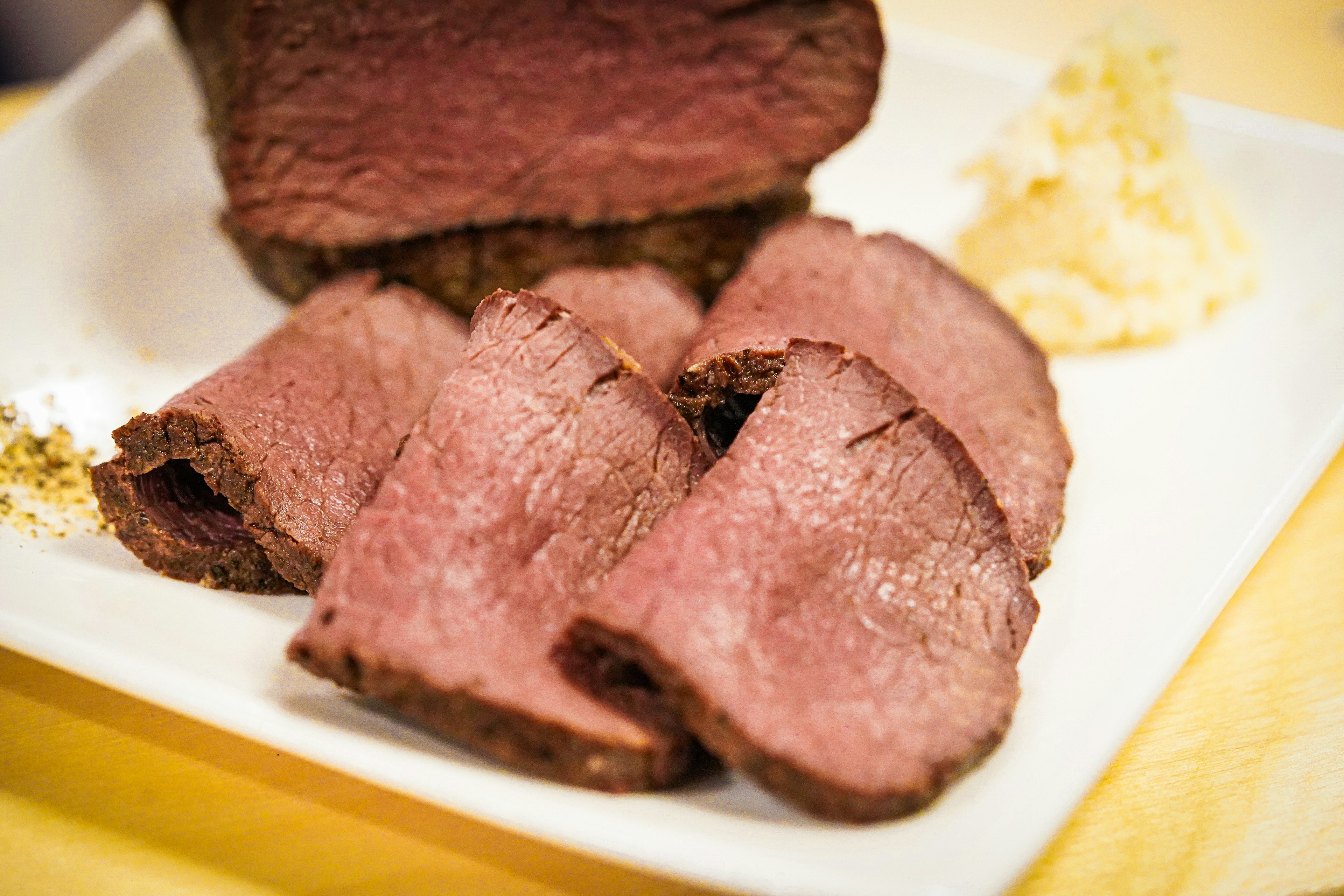 Sliced roast beef served with wasabi on a plate