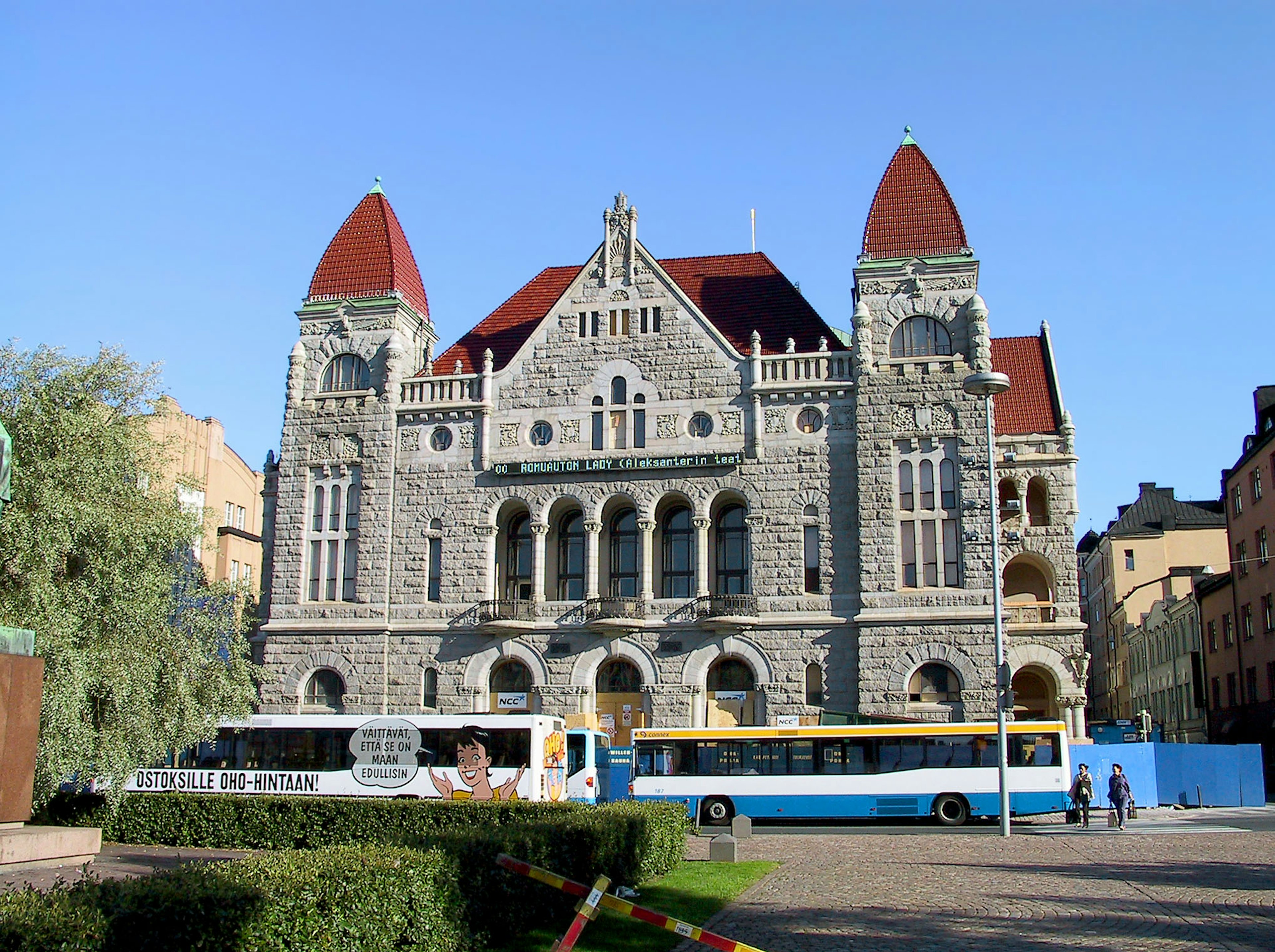 Historic stone building featuring red spires