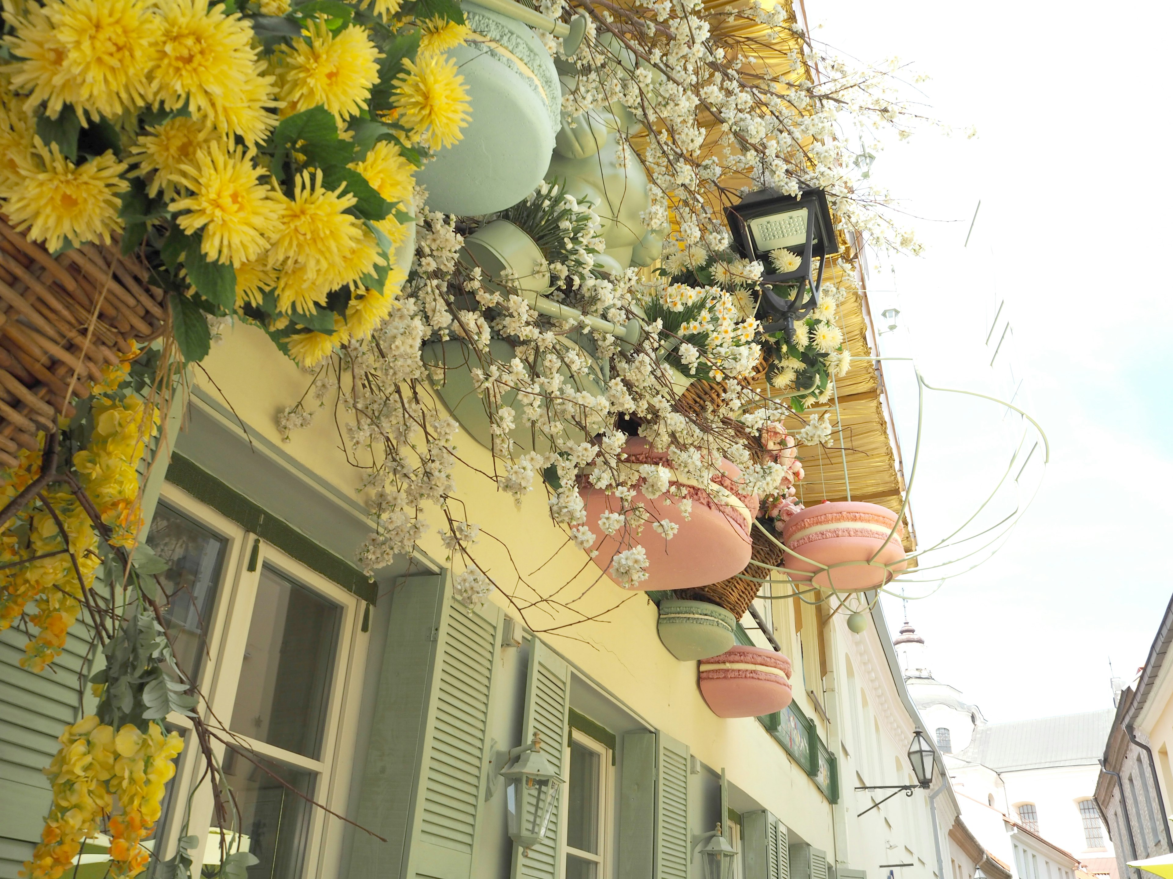 Esterno di un edificio decorato con fiori colorati e vasi appesi