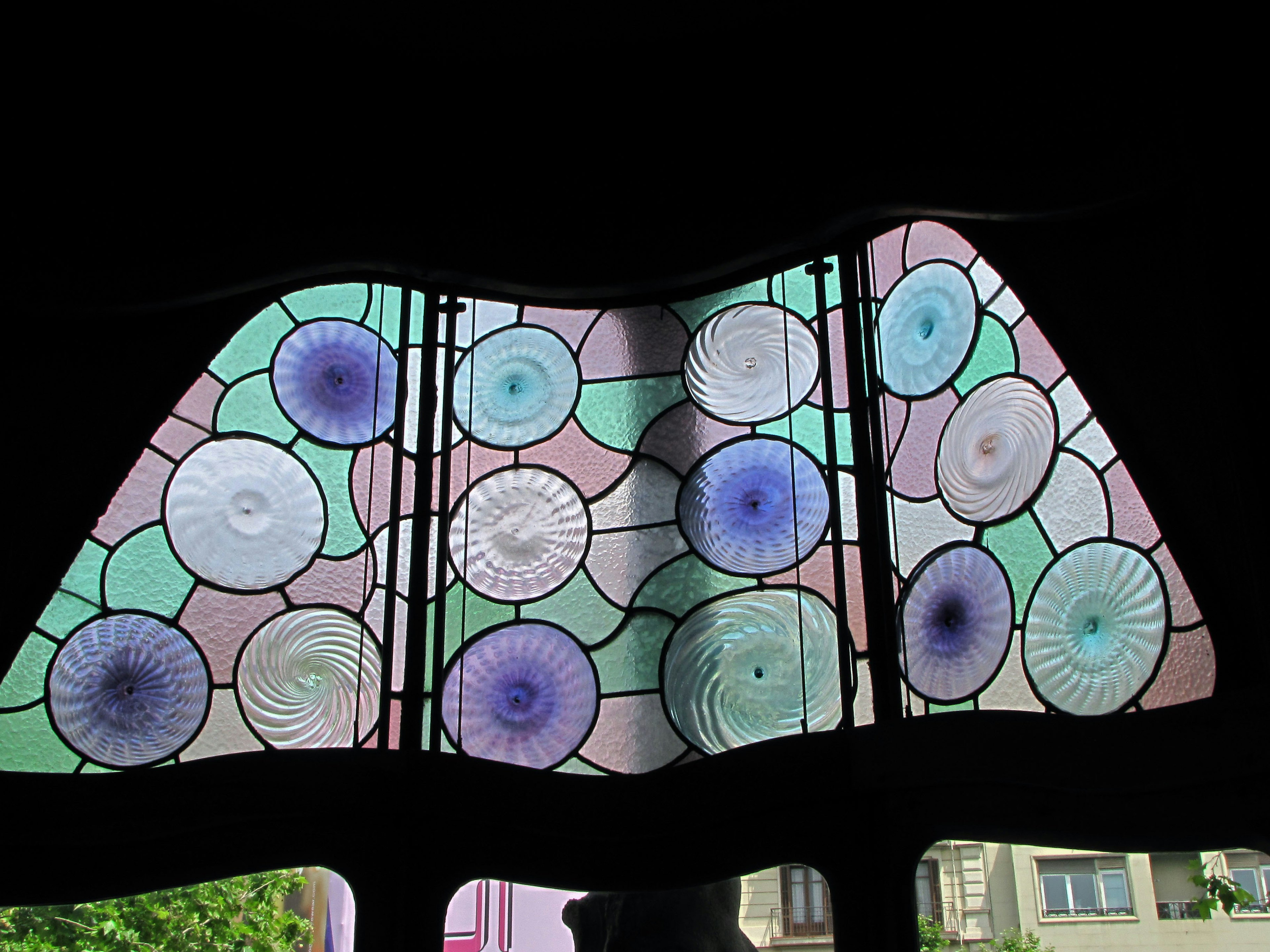 Colorful stained glass window featuring circular designs