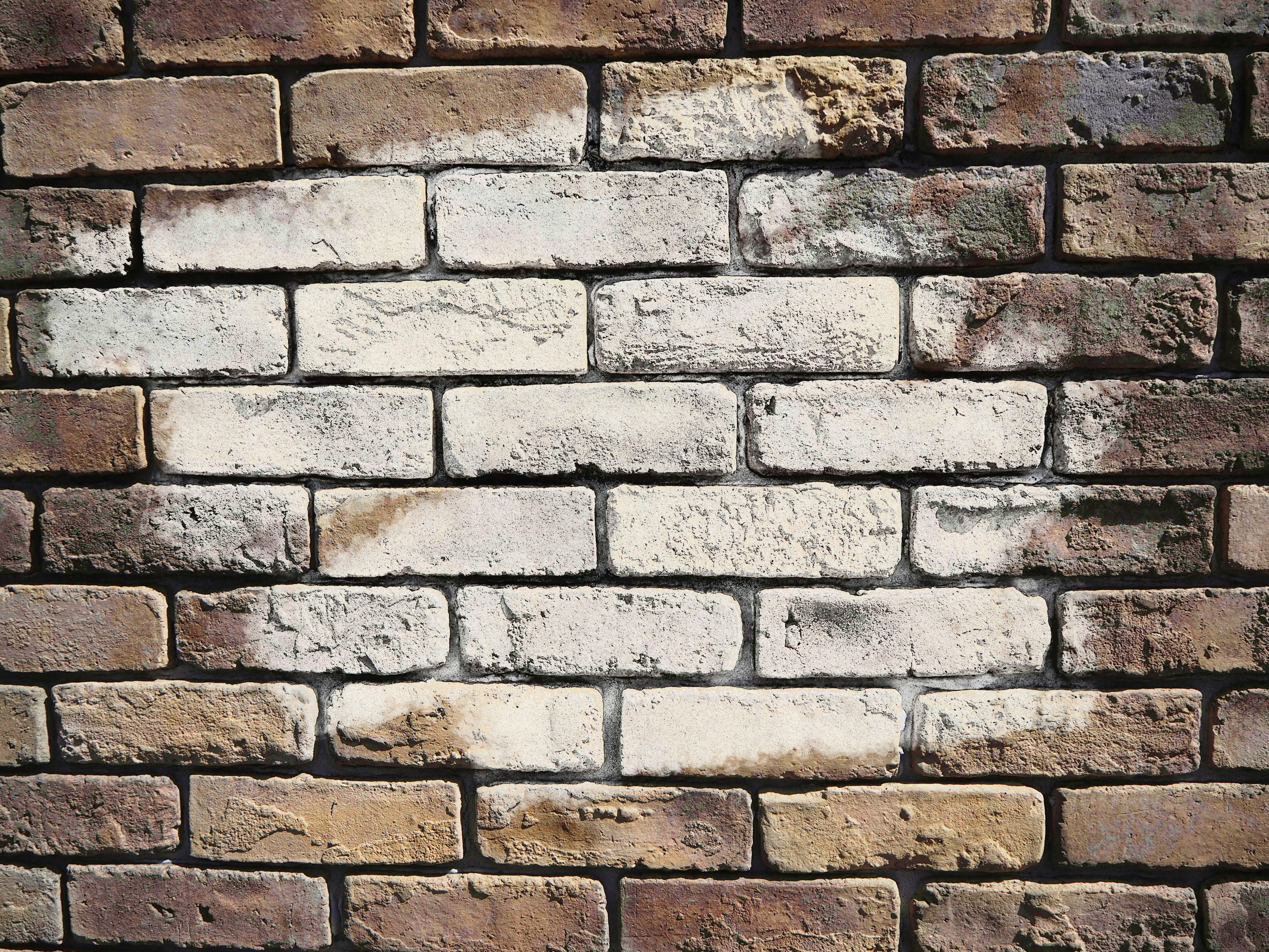 Textured wall of brown and white bricks