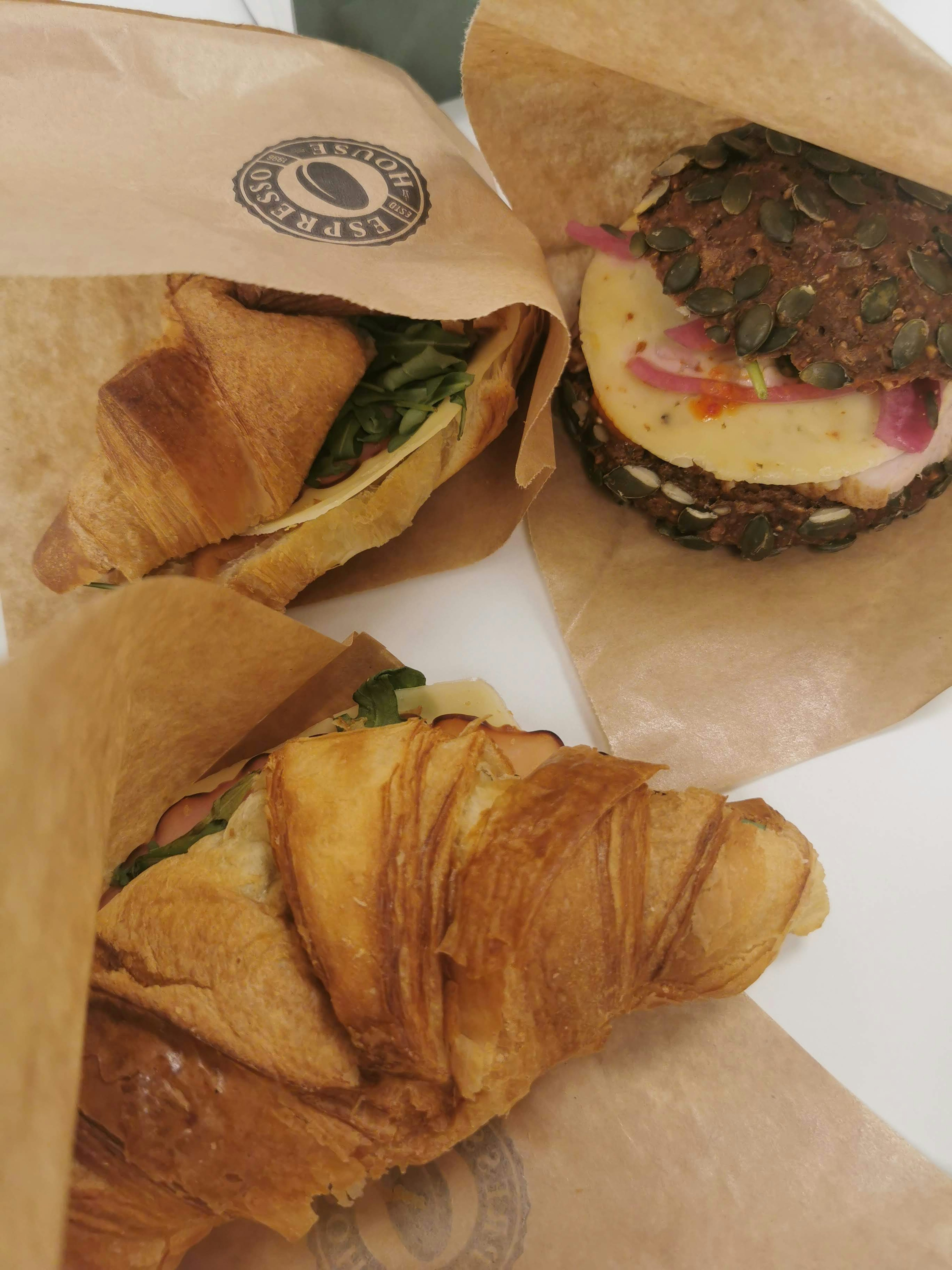 Image of croissants and a sandwich arranged on a table