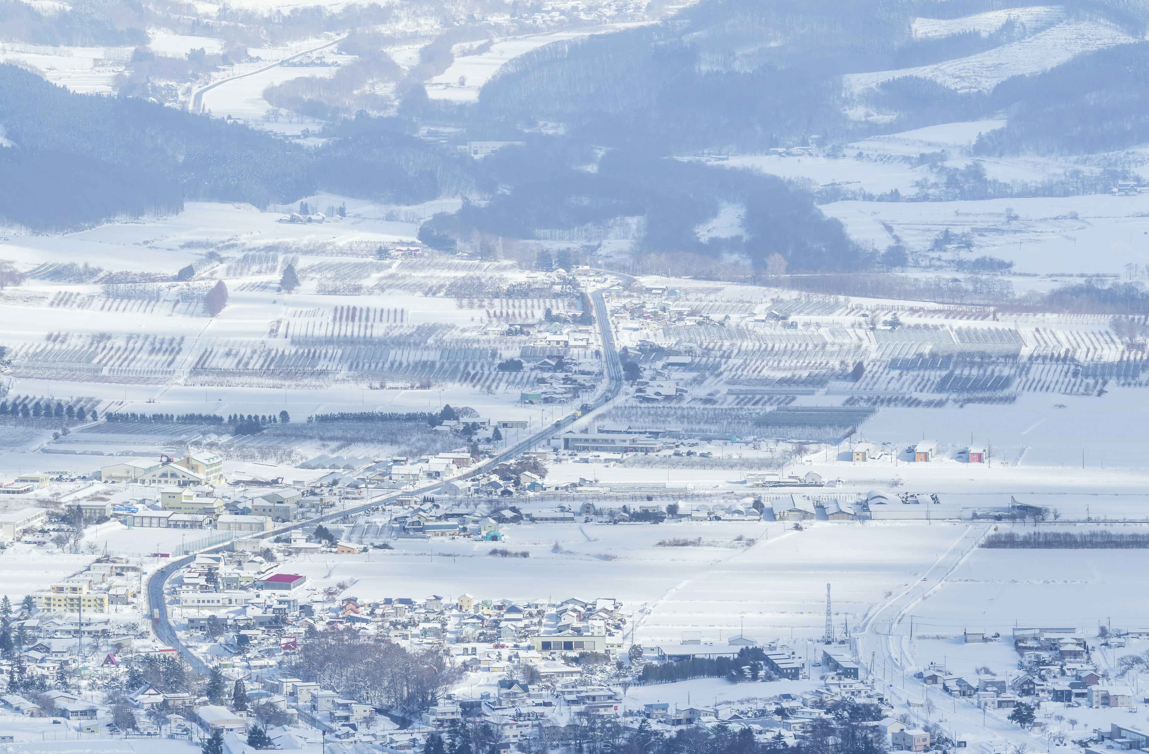 Snow-covered village with vast landscape