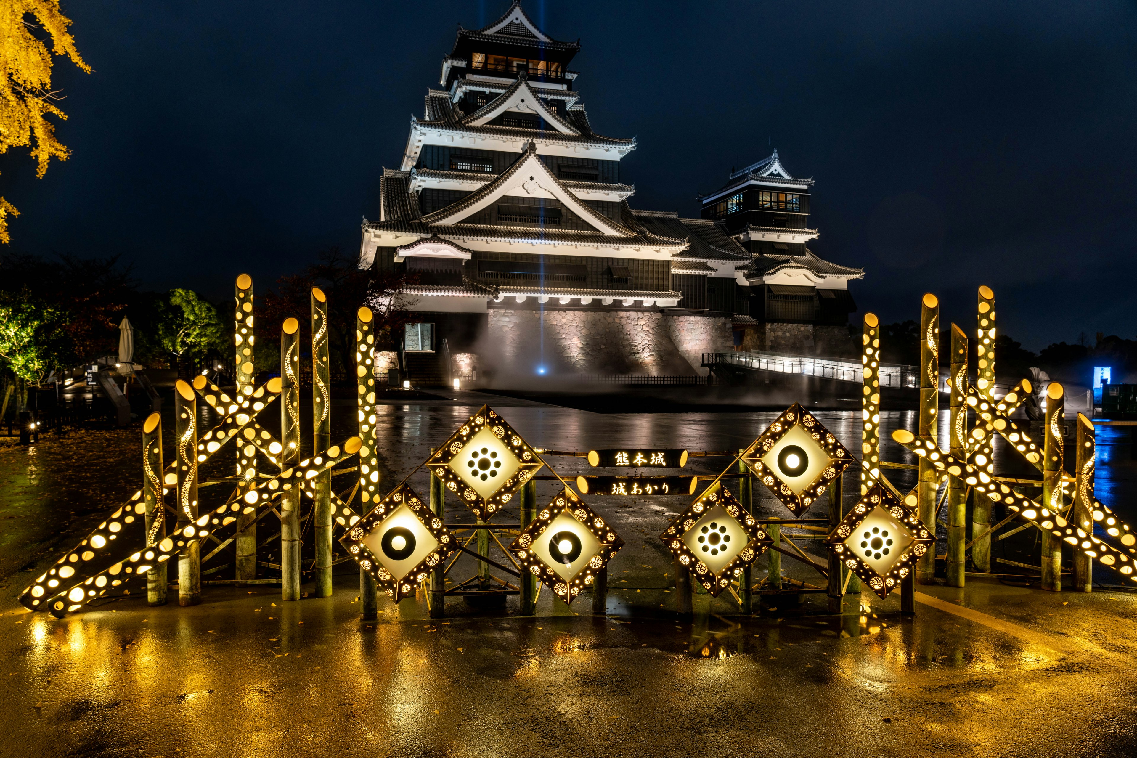 Castle illuminated at night with decorative gate