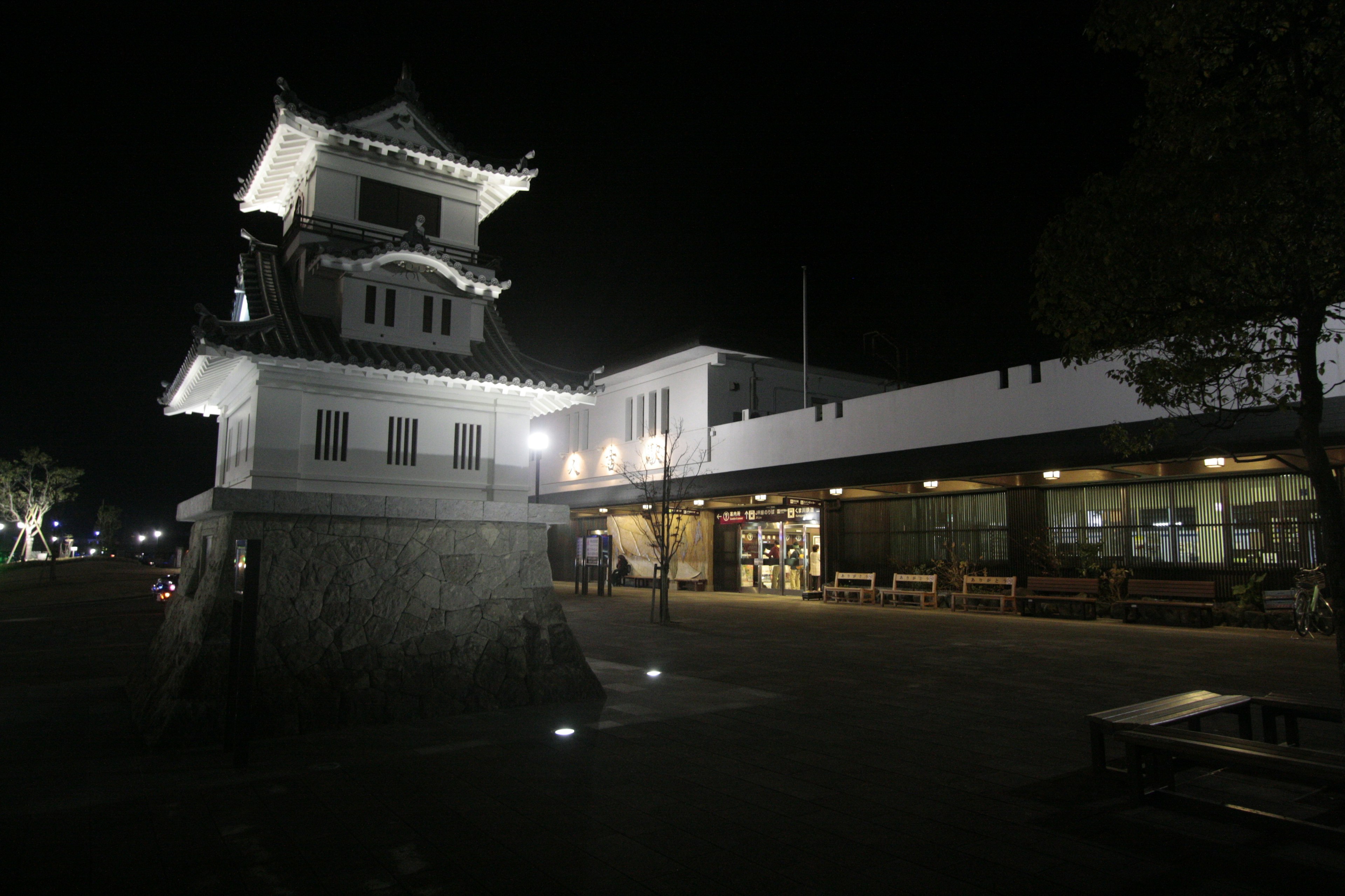 Pemandangan malam menara kastil di samping bangunan modern