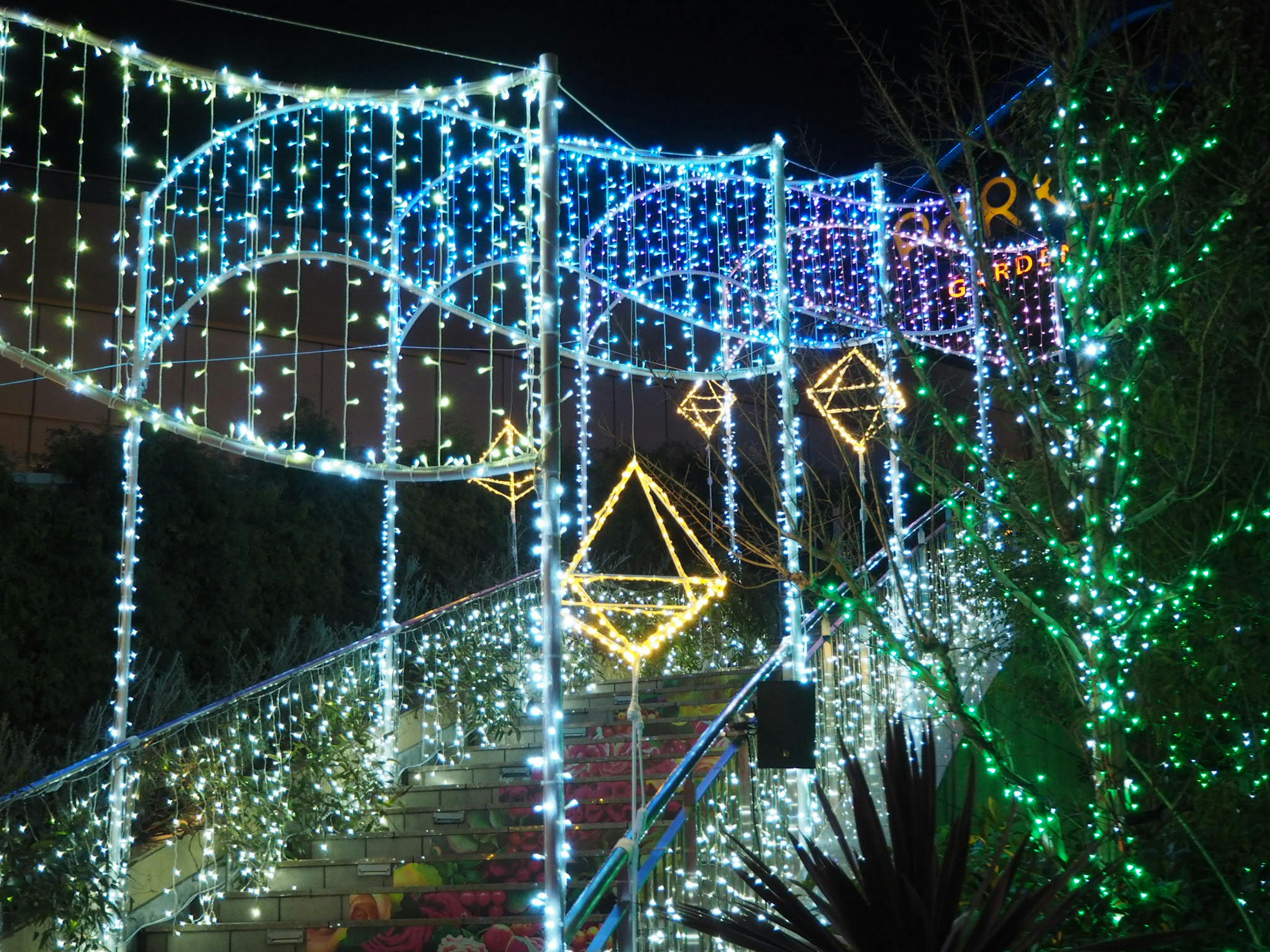 Decorative LED lights illuminating a staircase and arch at night