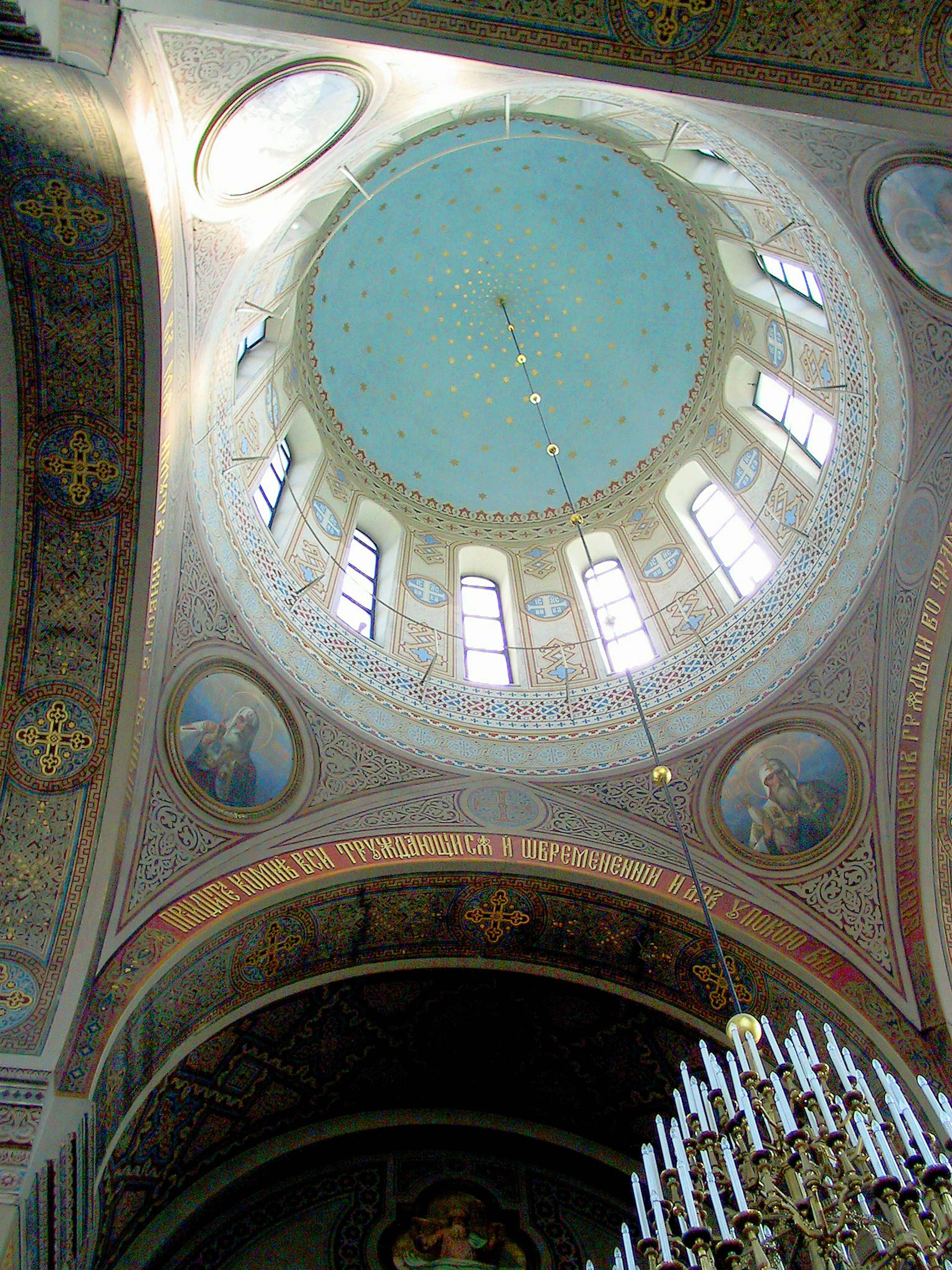 Interior view of a beautiful dome featuring a chandelier and wall paintings