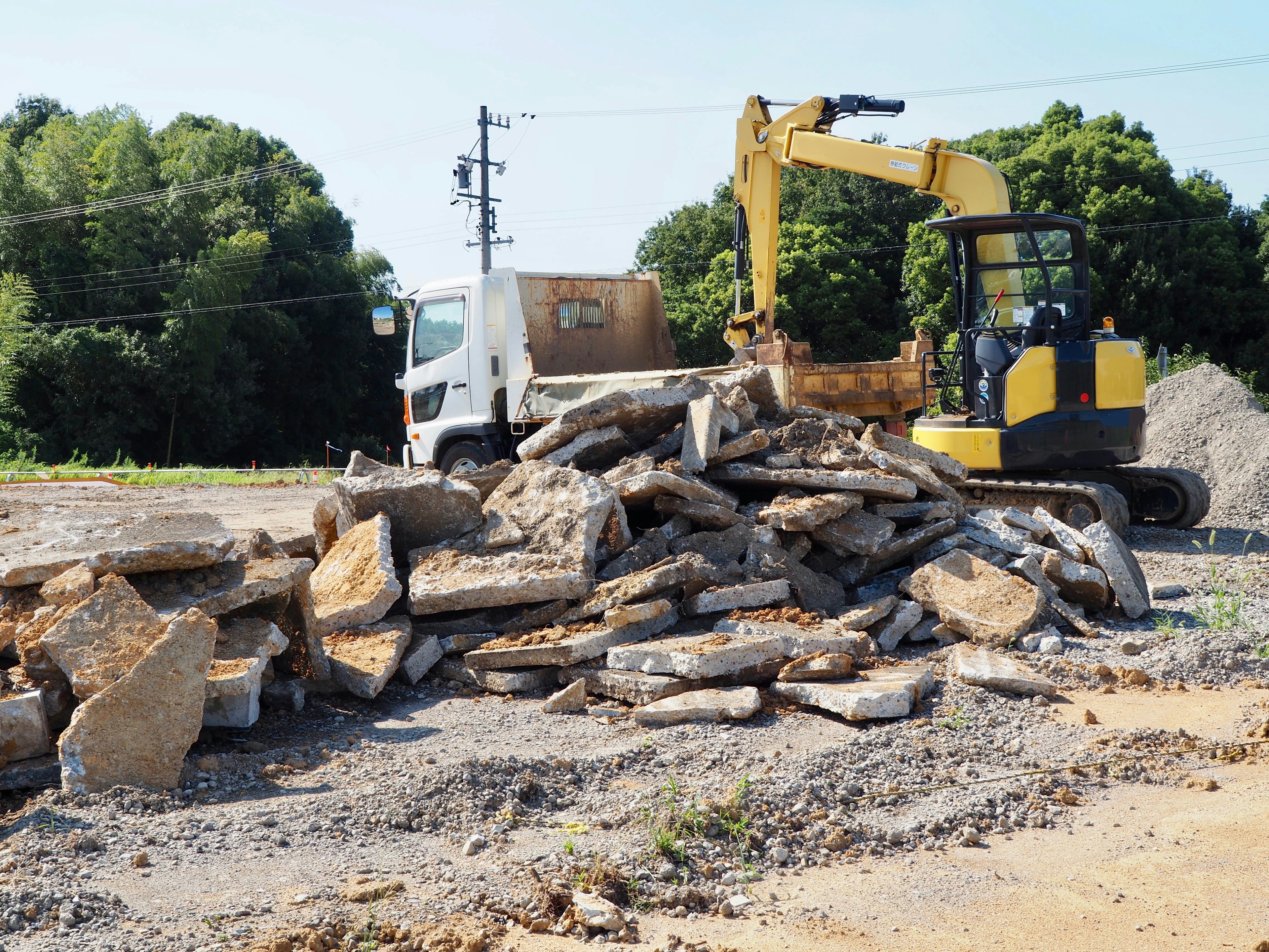 Construction site with heavy machinery and a pile of stones