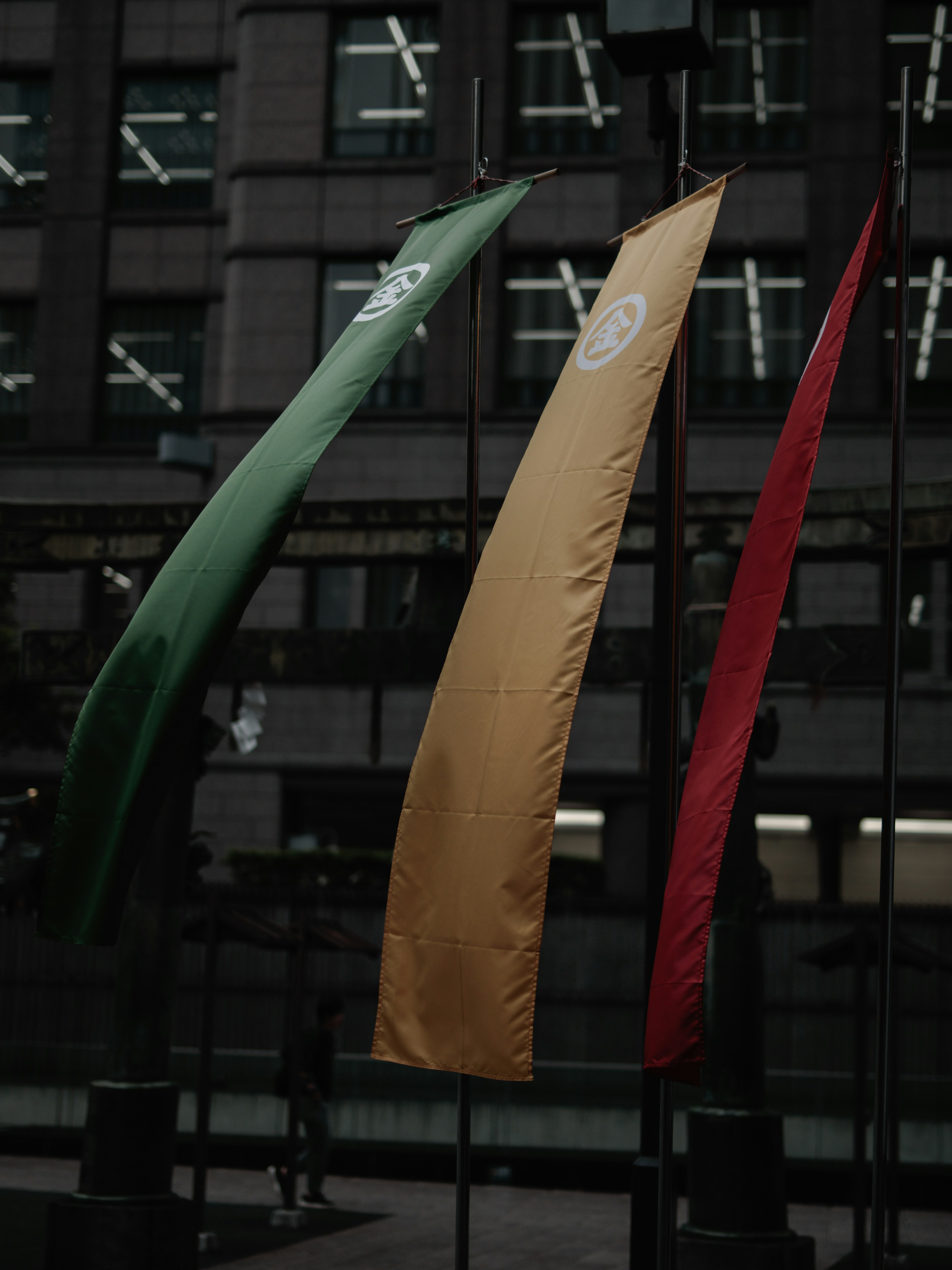 Green yellow and red flags displayed in an urban setting