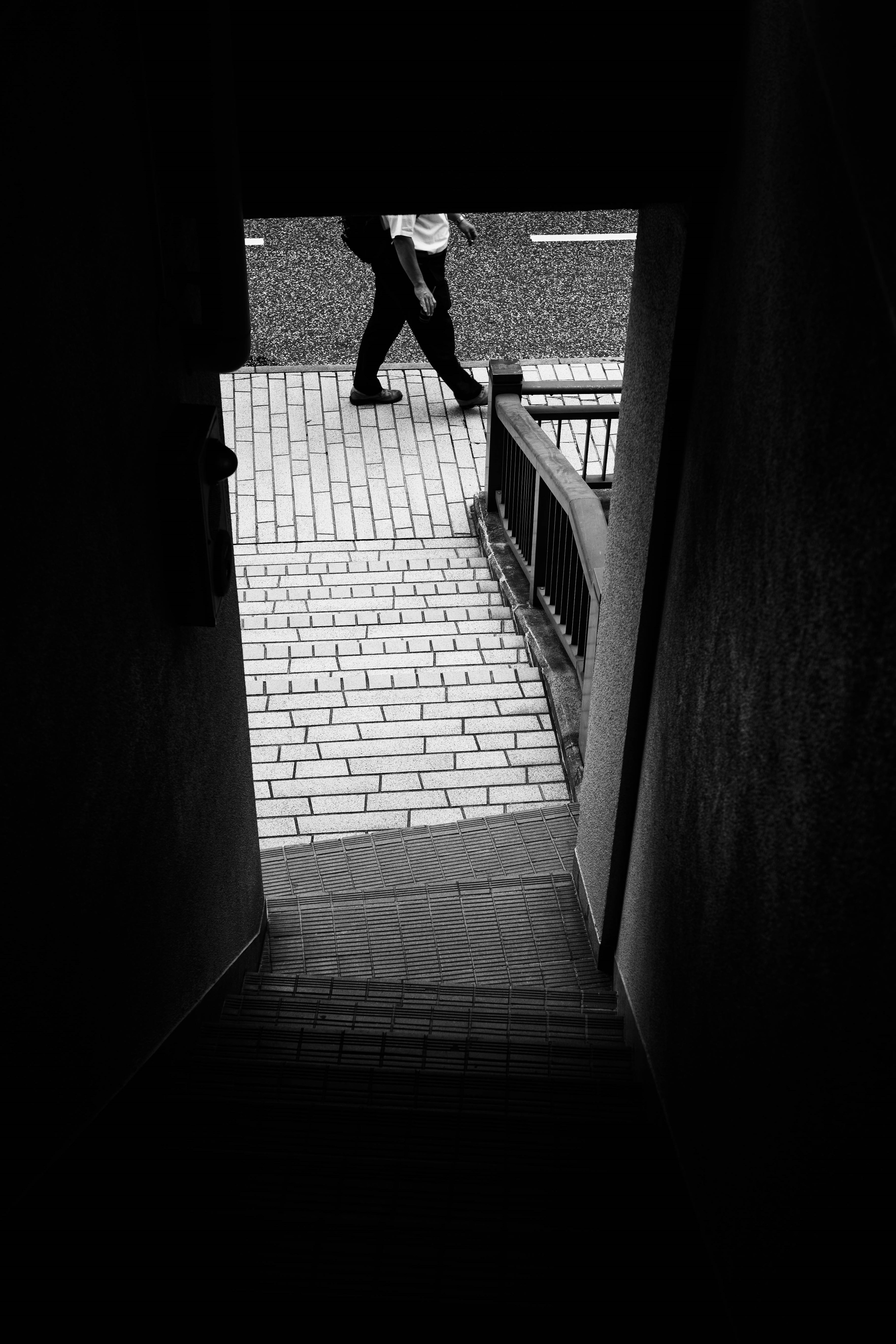 Image of a dark doorway with a person walking on the street