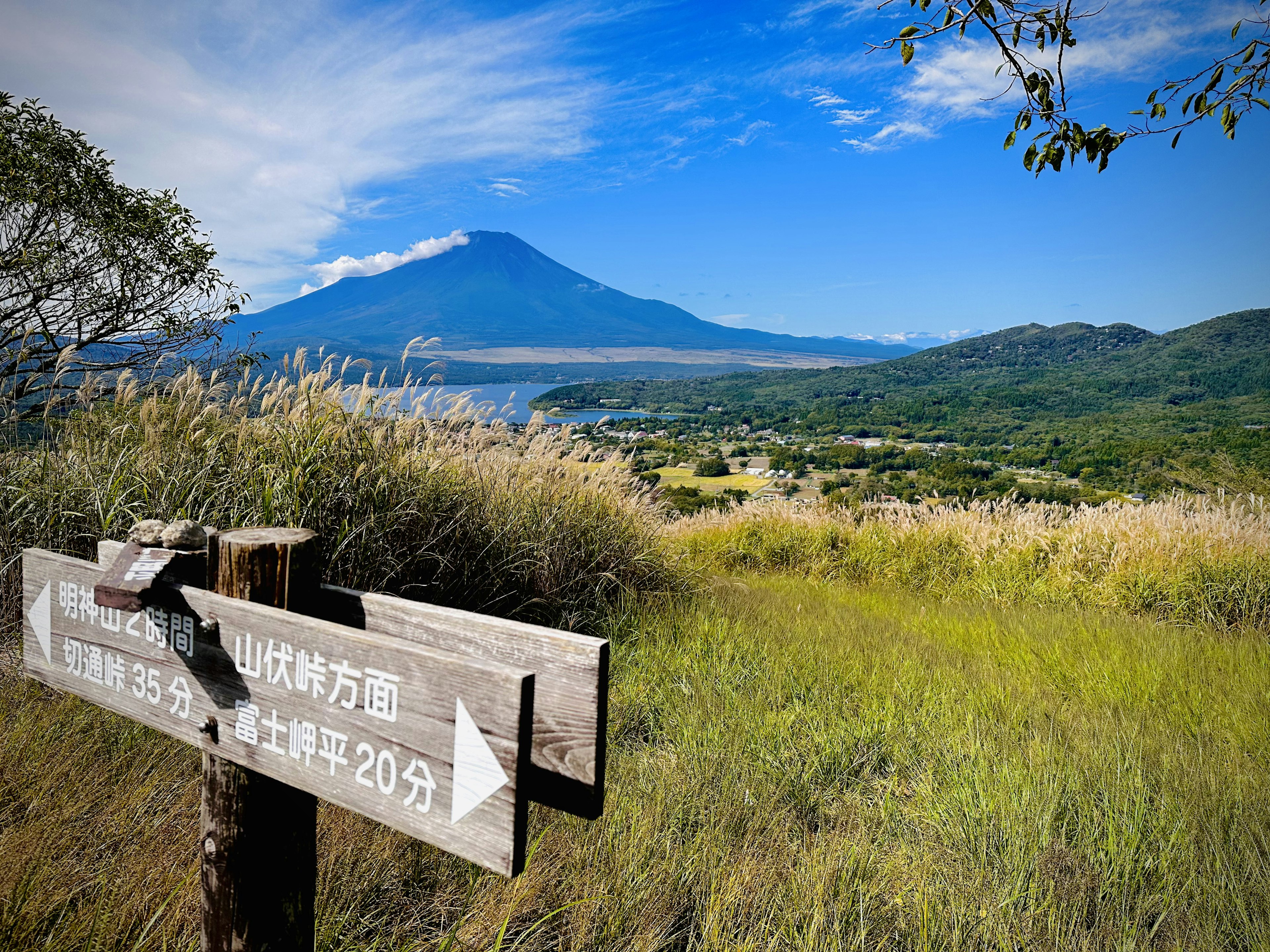 Signpost in front of a mountain and blue sky