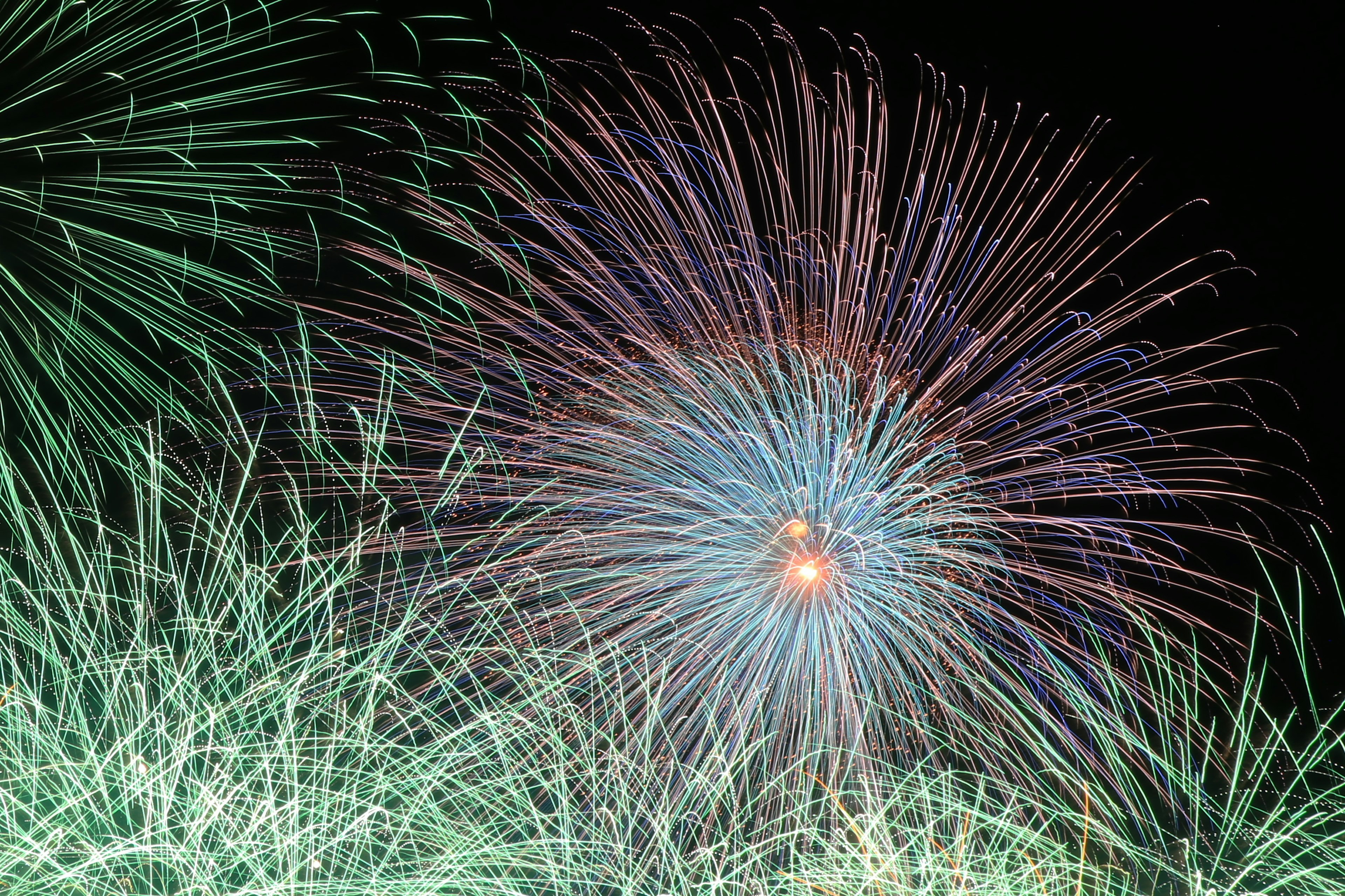 Espectáculo de fuegos artificiales coloridos estallando en el cielo nocturno con patrones vibrantes