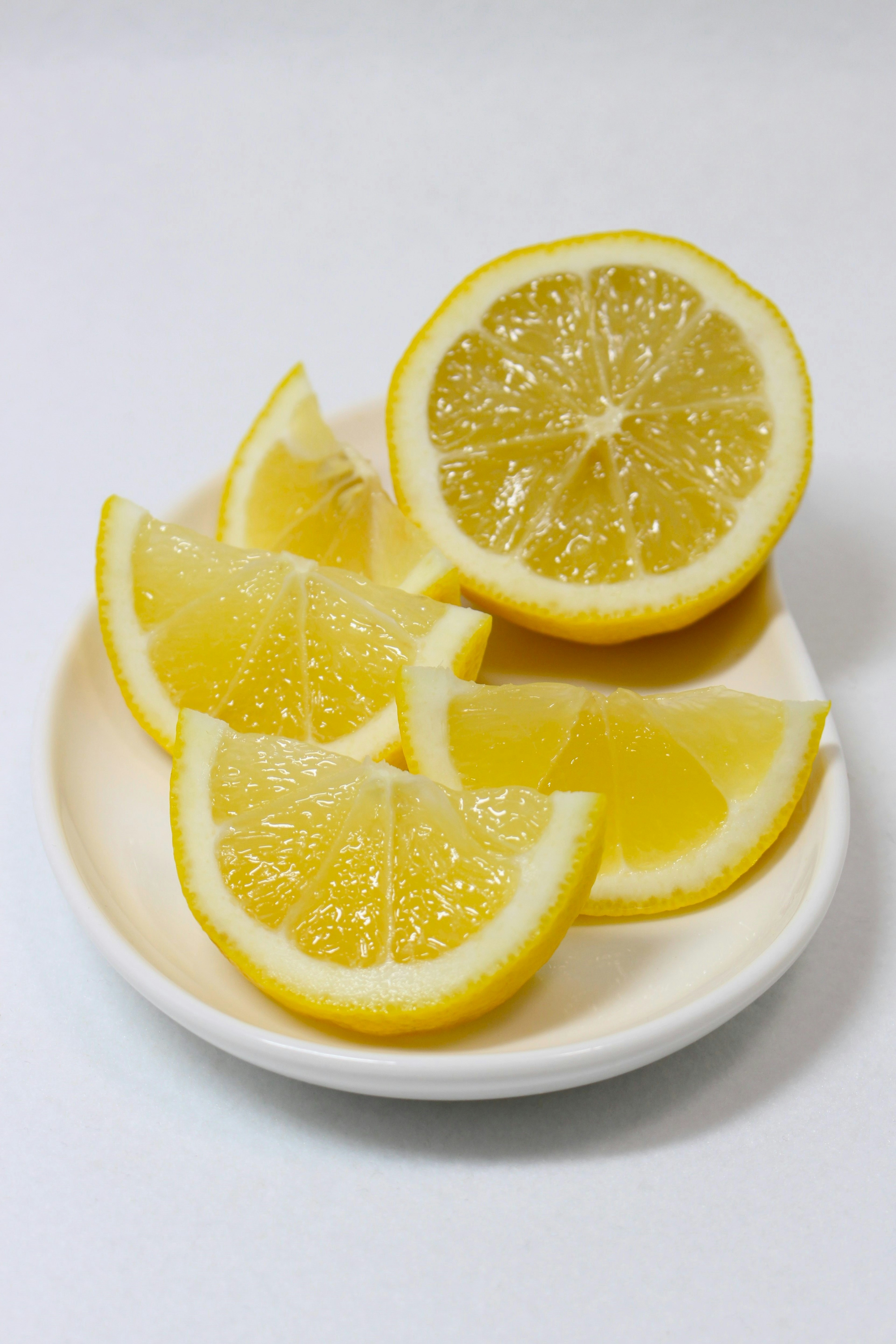 Slices of lemon arranged on a small white plate